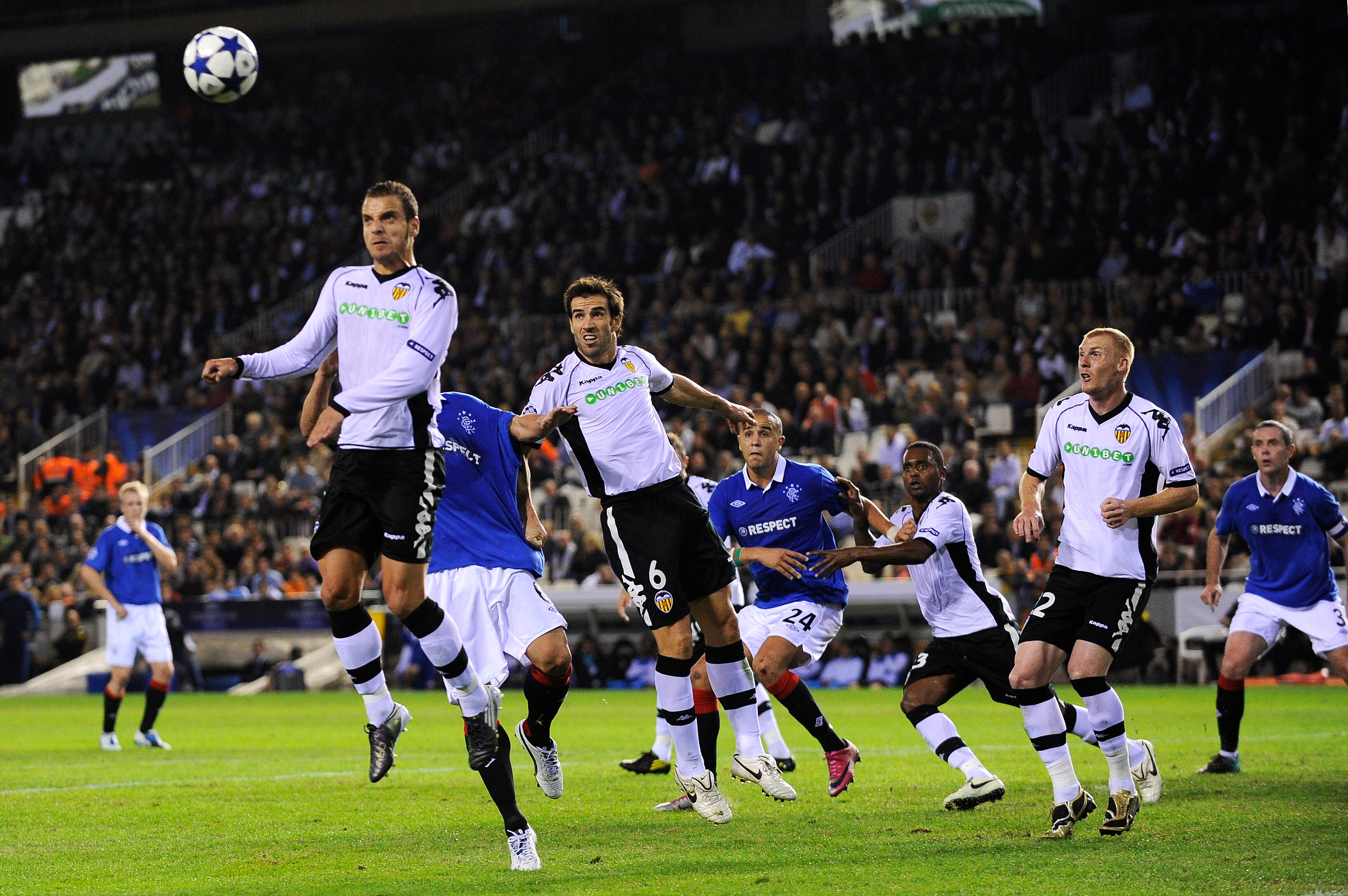 VALENCIA, SPAIN - NOVEMBER 02: Roberto Soldado of Valencia (L) heads a high ball during their UEFA Champions League group C match between Valencia CF and Glasgow Rangers at the Mestalla Stadium on November 2, 2010 in Valencia, Spain.  (Photo by David Ramo