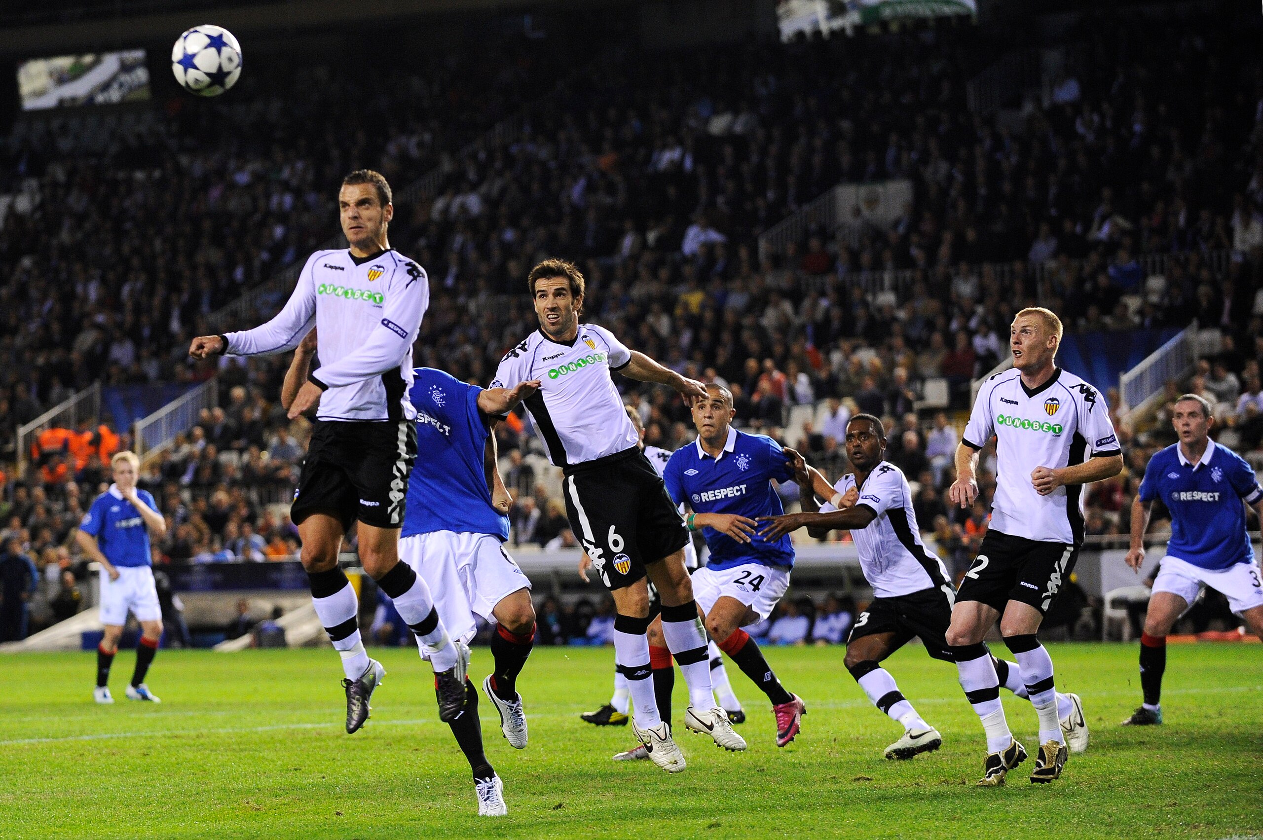 VALENCIA, SPAIN - NOVEMBER 02: Roberto Soldado of Valencia (L) heads a high ball during their UEFA Champions League group C match between Valencia CF and Glasgow Rangers at the Mestalla Stadium on November 2, 2010 in Valencia, Spain.  (Photo by David Ramo