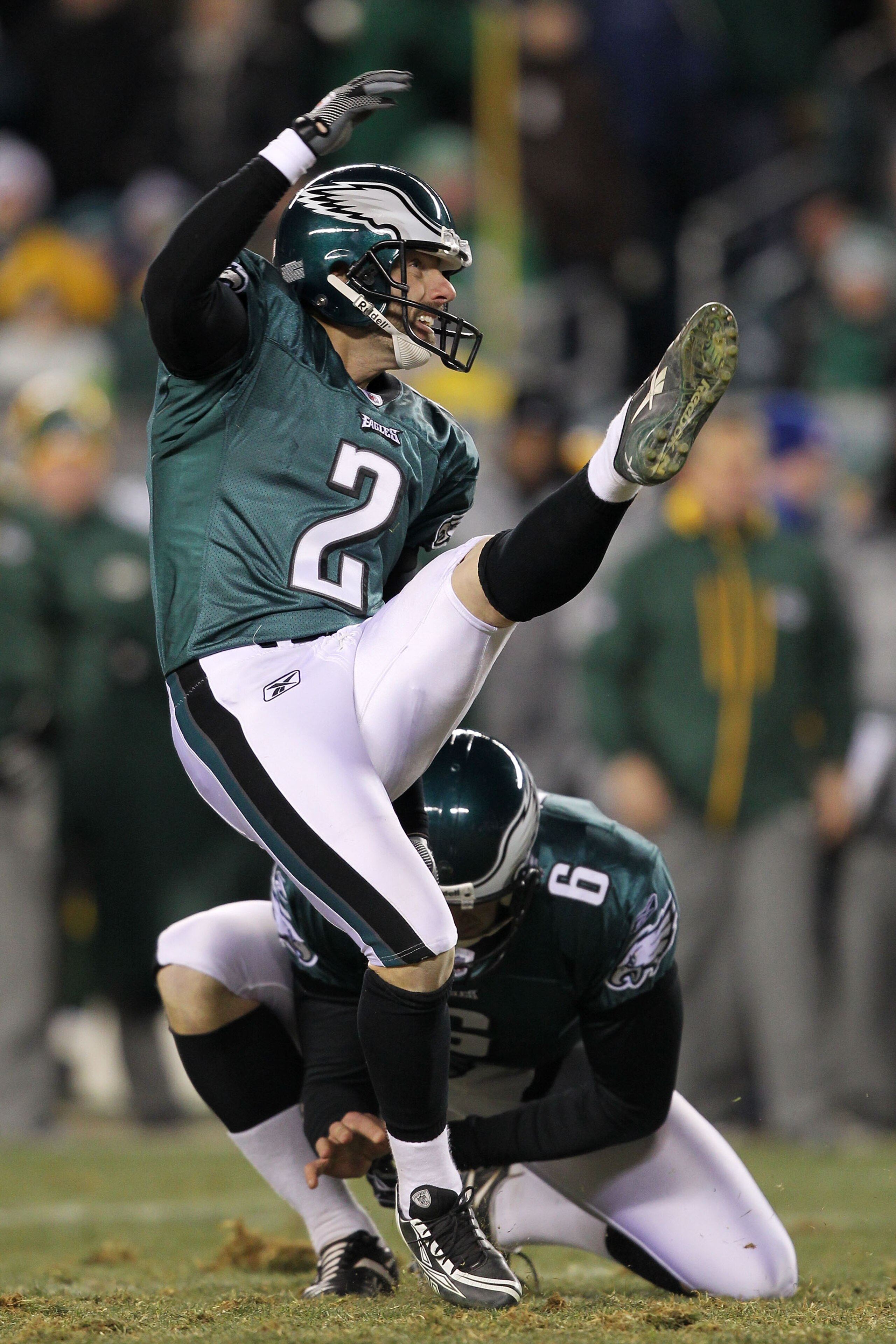 PHILADELPHIA, PA - JANUARY 09:  David Akers #2 kicks as Sav Rocca #6 of the Philadelphia Eagles holds against the Green Bay Packers during the 2011 NFC wild card playoff game at Lincoln Financial Field on January 9, 2011 in Philadelphia, Pennsylvania.  (P