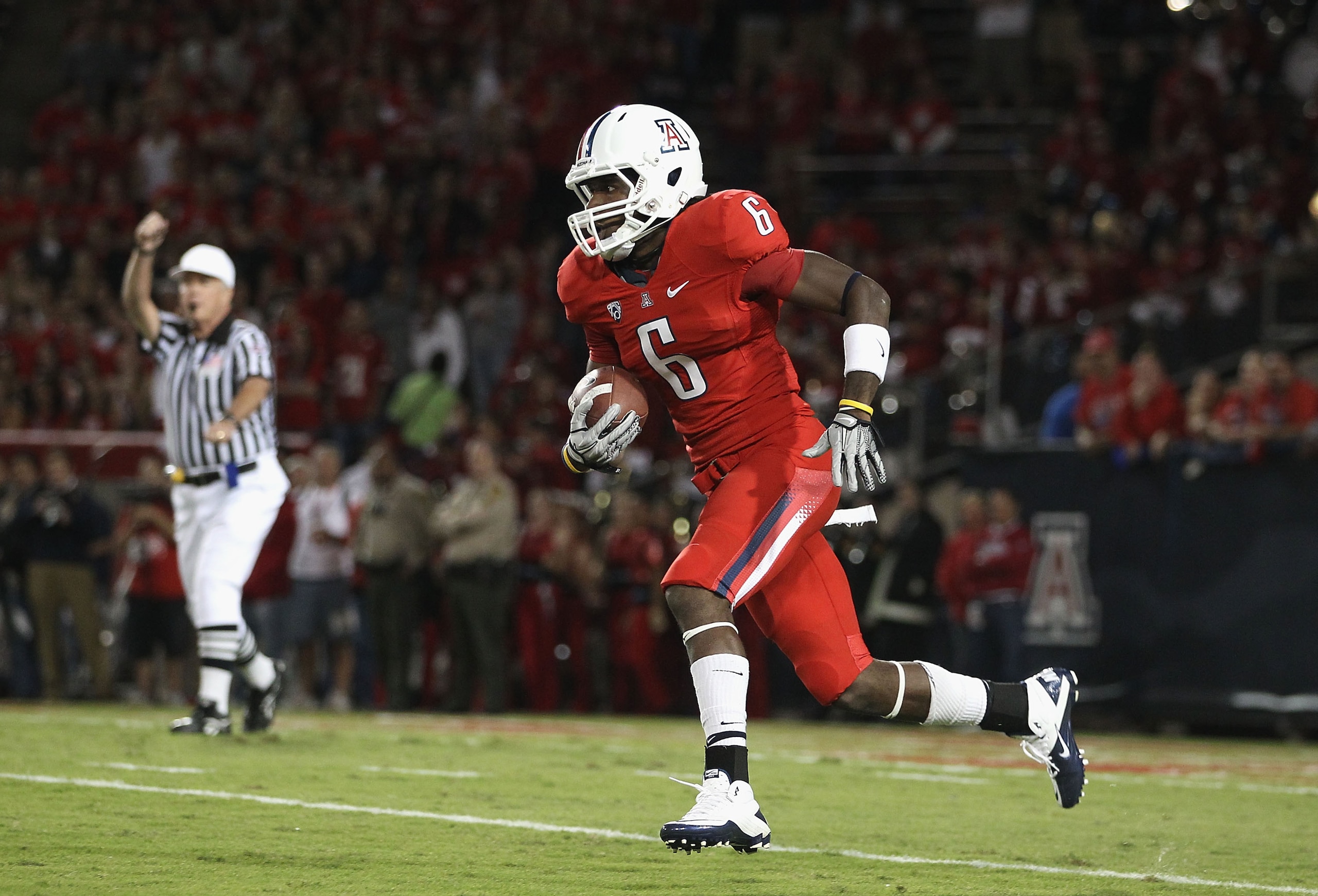 TUCSON, AZ - OCTOBER 23: Travis Cobb #6 of the Arizona Wildcats runs with the ball during the college football game against the Washington Huskies at Arizona Stadium on October 23, 2010 in Tucson, Arizona. The Wildcats defeated the Huskies 44-14. (Pho TUCSON, AZ - OCTOBER 23: Travis Cobb #6 of the Arizona Wildcats runs with the ball during the college football game against the Washington Huskies at Arizona Stadium on October 23, 2010 in Tucson, Arizona. The Wildcats defeated the Huskies 44-14. (Pho