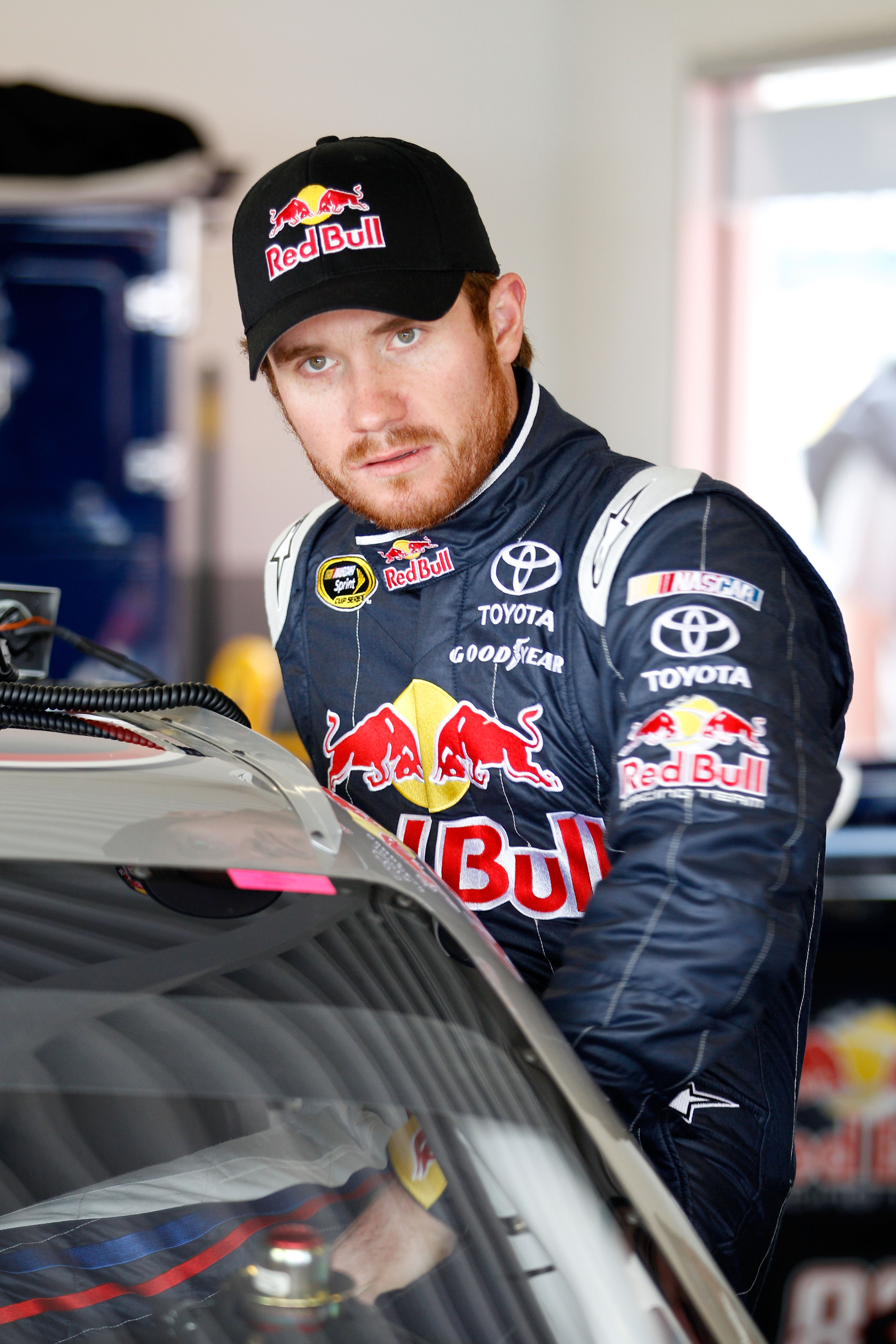 DAYTONA BEACH, FL - FEBRUARY 16:  Brian Vickers, driver of the #83 Red Bull Toyota, gets into his car in the garage area during practice for the NASCAR Sprint Cup Series Daytona 500 at Daytona International Speedway on February 16, 2011 in Daytona Beach,