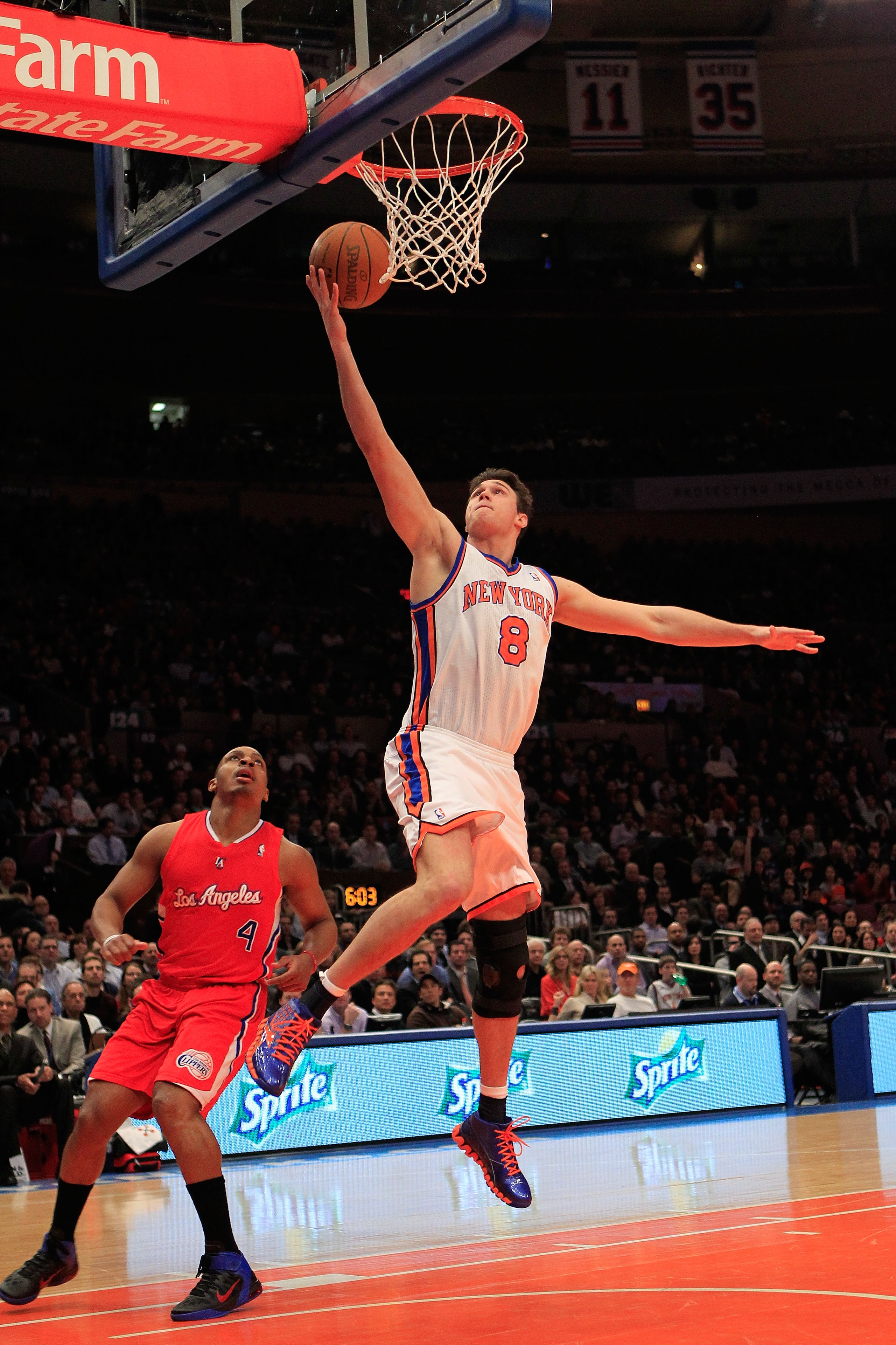 NEW YORK, NY - FEBRUARY 09: Danilo Gallinari #8 of the New York Knicks lays the ball up over Randy Foye #4 of the Los Angeles Clippers at Madison Square Garden on February 9, 2011 in New York City. NOTE TO USER: User expressly acknowledges and agrees that