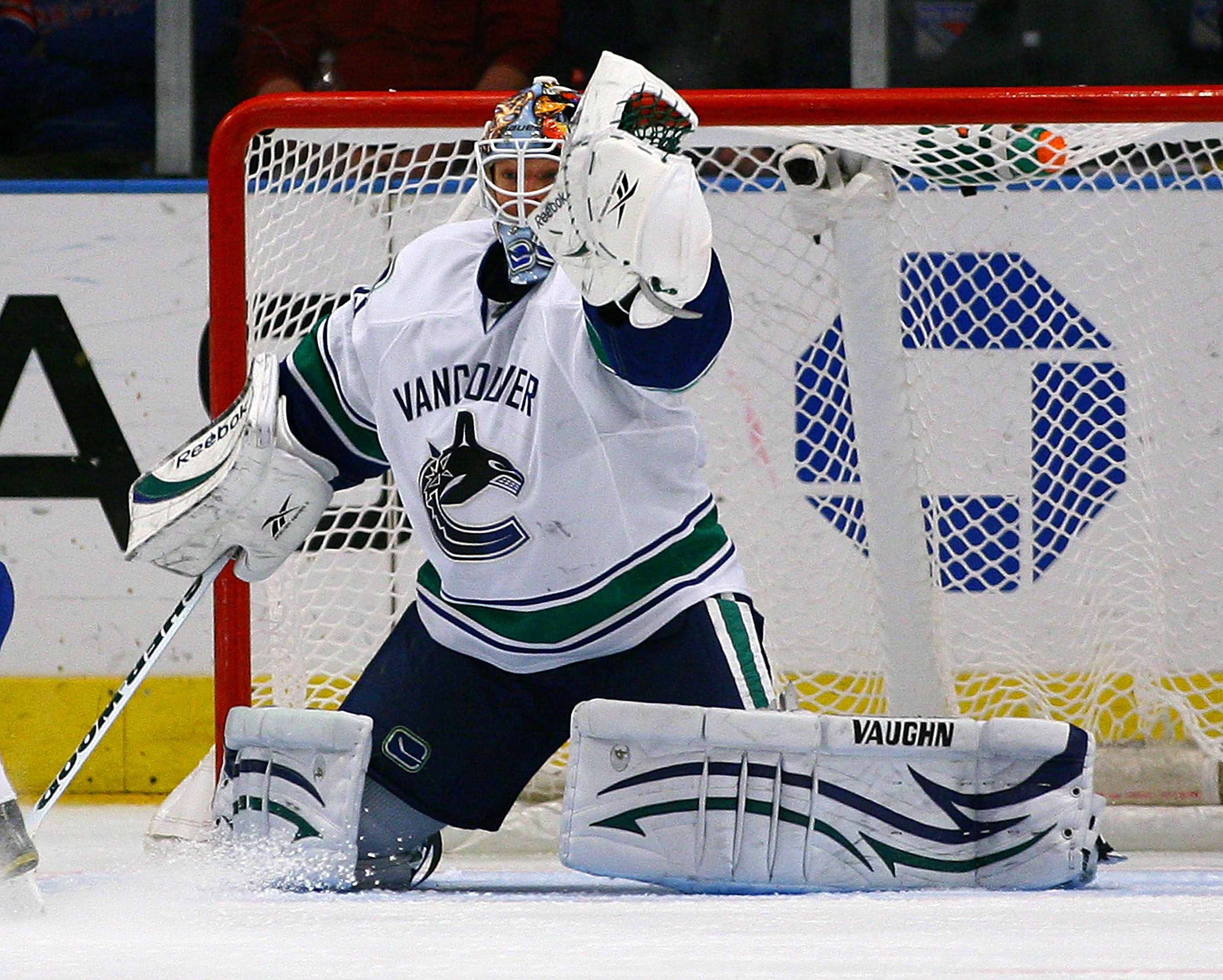 NEW YORK , NY - JANUARY 13: Goaltender Cory Schneider #35 of the Vancouver Canucks makes a glove save against the New York Rangers during the game at Madison Square Garden on January 13, 2011 in New York City. (Photo by Andy Marlin/Getty Images)