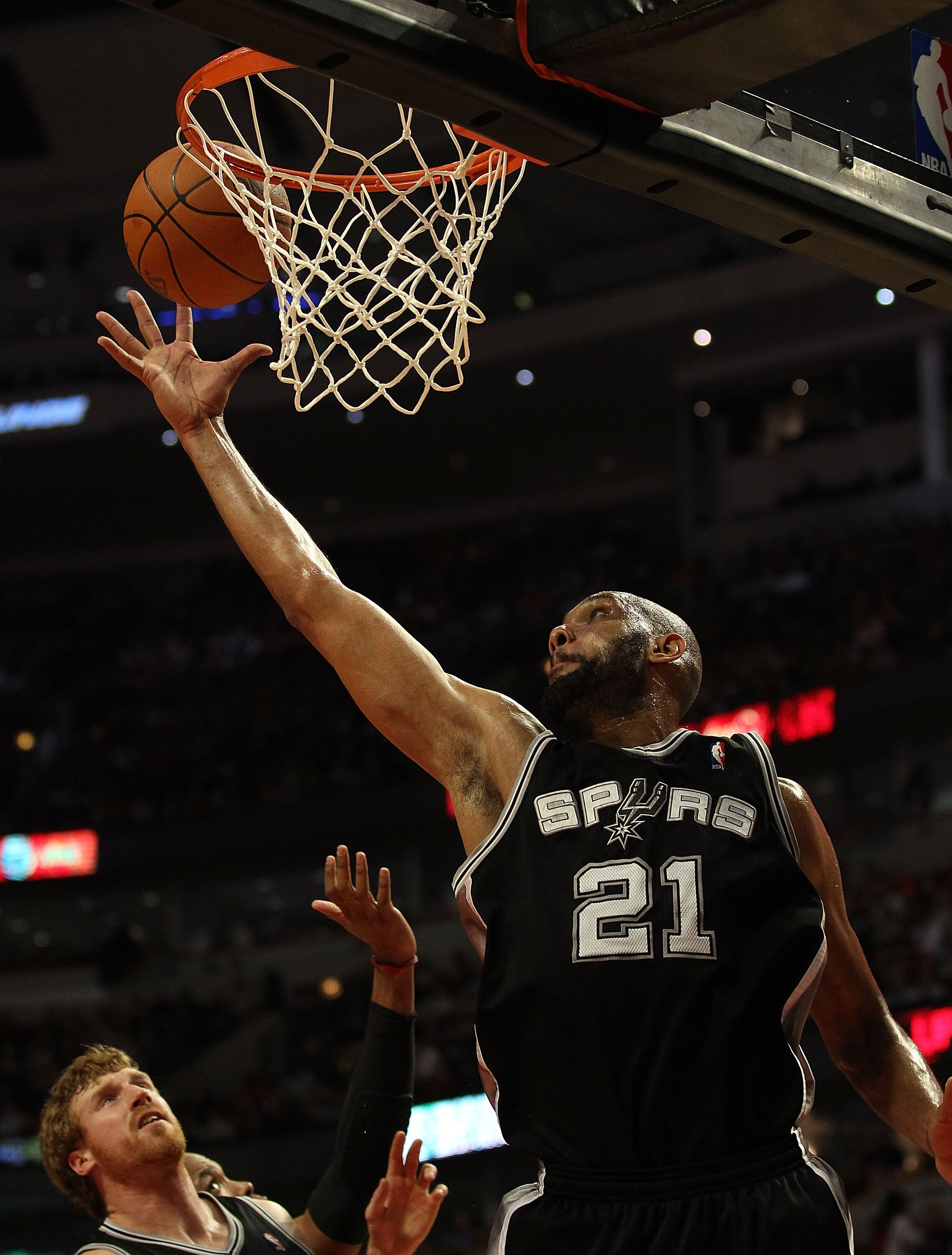 CHICAGO, IL - FEBRUARY 17: Tim Duncan #21 of the San Antonio Spurs grabs a rebound against the Chicago Bulls at the United Center on February 17, 2011 in Chicago, Illinois. The Bulls defeated the Spurs 109-99. NOTE TO USER: User expressly acknowledges and