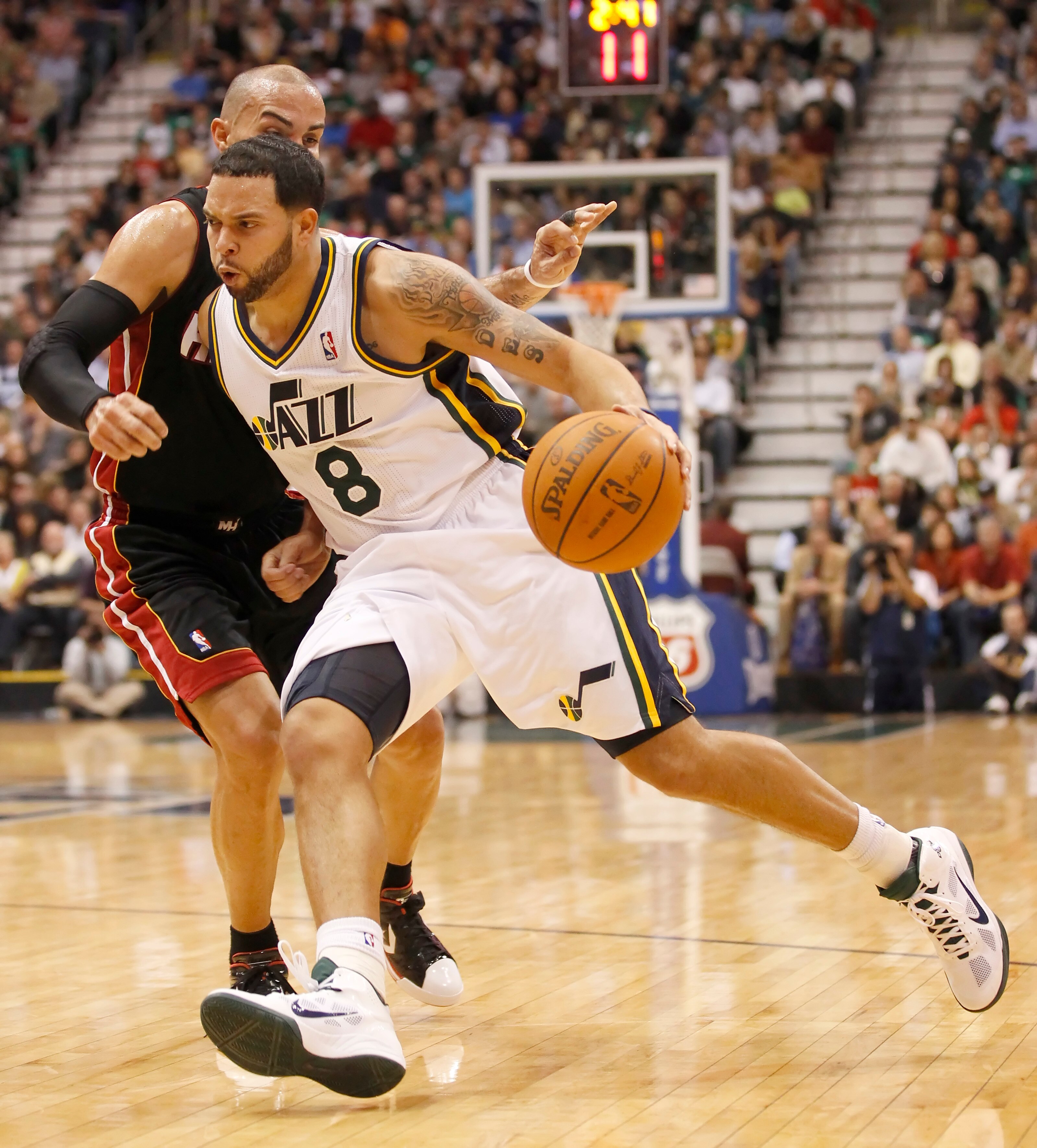 SALT LAKE CITY, UT - DECEMBER 8:  Deron Williams #8 of the Utah Jazz drives on Carlos Arroyo #8 the Miami Heat during the second half of an NBA game December 8, 2010 at Energy Solutions Arena in Salt Lake City, Utah. The Heat beat the Jazz 111-98. NOTE TO
