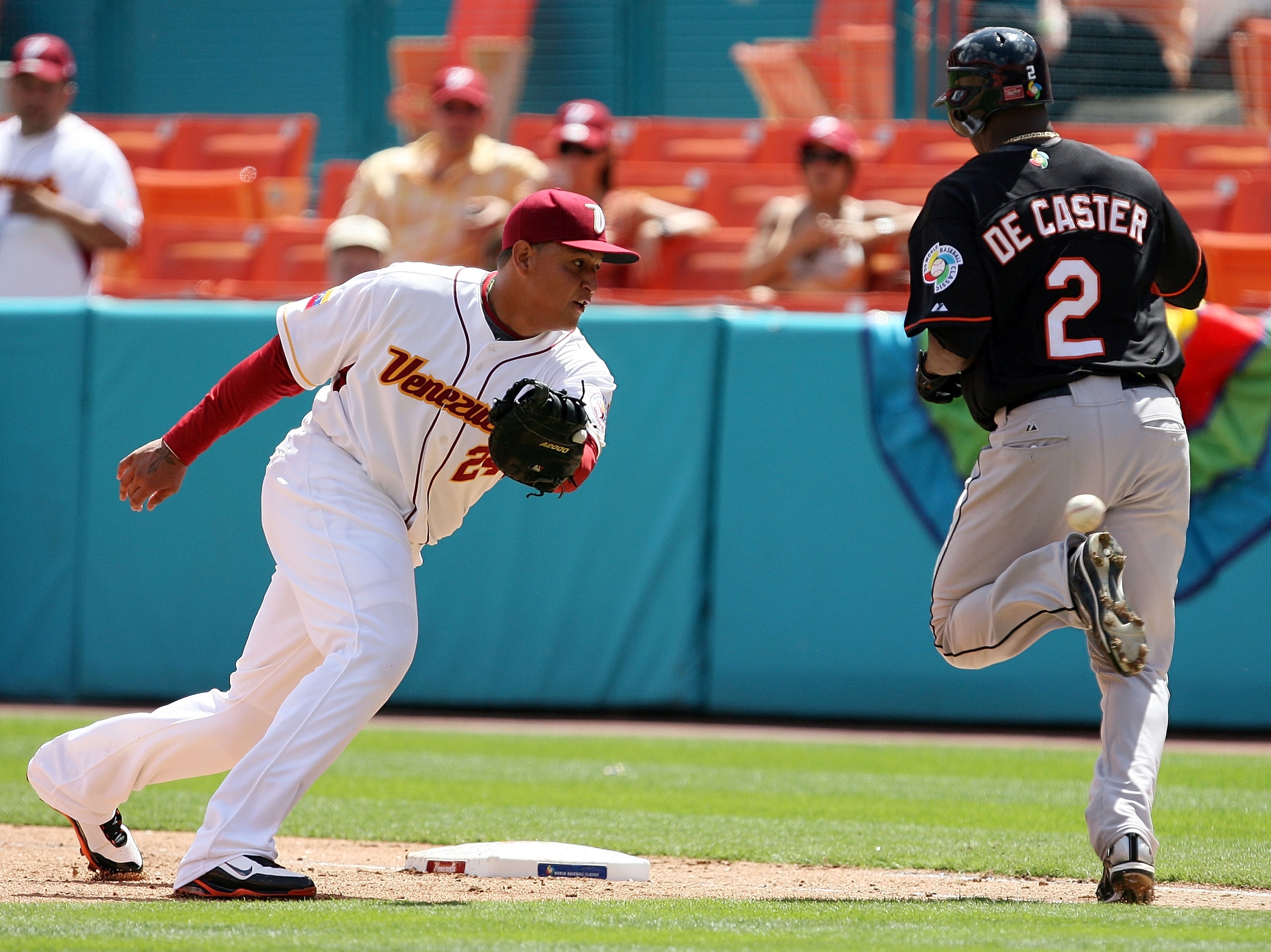 MIAMI - MARCH 14:  Miguel Cabrera #24 of Venezuela can't knock down a bad throw as Yurendell DeCaster #2 of the Netherlands reaches base during round 2 of the World Baseball Classic at Dolphin Stadium on March 14, 2009 in Miami, Florida.  (Photo by Doug B