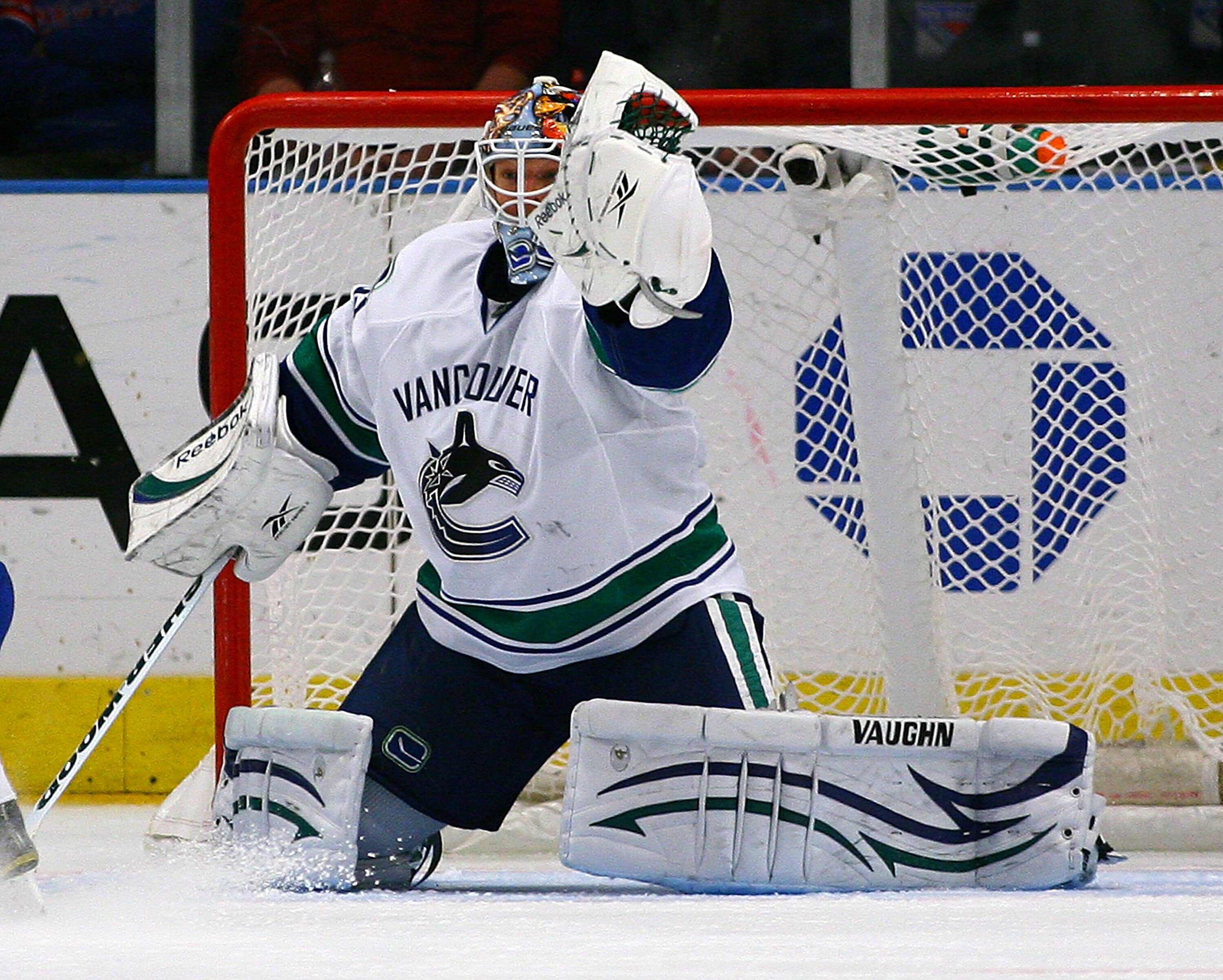NEW YORK , NY - JANUARY 13: Goaltender Cory Schneider #35 of the Vancouver Canucks makes a glove save against the New York Rangers during the game at Madison Square Garden on January 13, 2011 in New York City. (Photo by Andy Marlin/Getty Images)