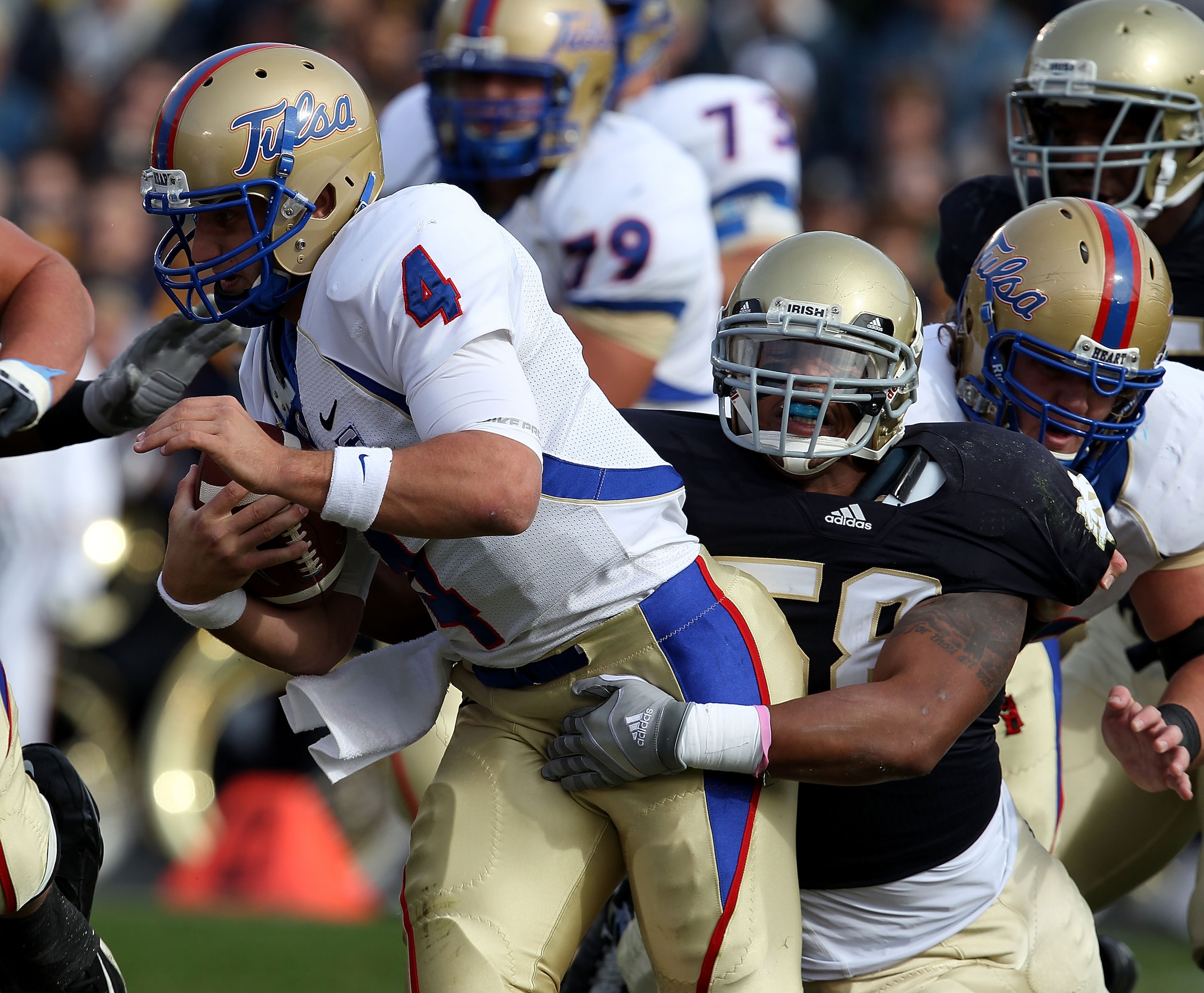 SOUTH BEND, IN - OCTOBER 30: Brian Smith #58 of the Notre Dame Fighting Irish sacks G.J. Kinne #4 of the Tulsa Golden Hurricane at Notre Dame Stadium on October 30, 2010 in South Bend, Indiana. (Photo by Jonathan Daniel/Getty Images) SOUTH BEND, IN - OCTOBER 30: Brian Smith #58 of the Notre Dame Fighting Irish sacks G.J. Kinne #4 of the Tulsa Golden Hurricane at Notre Dame Stadium on October 30, 2010 in South Bend, Indiana. (Photo by Jonathan Daniel/Getty Images)