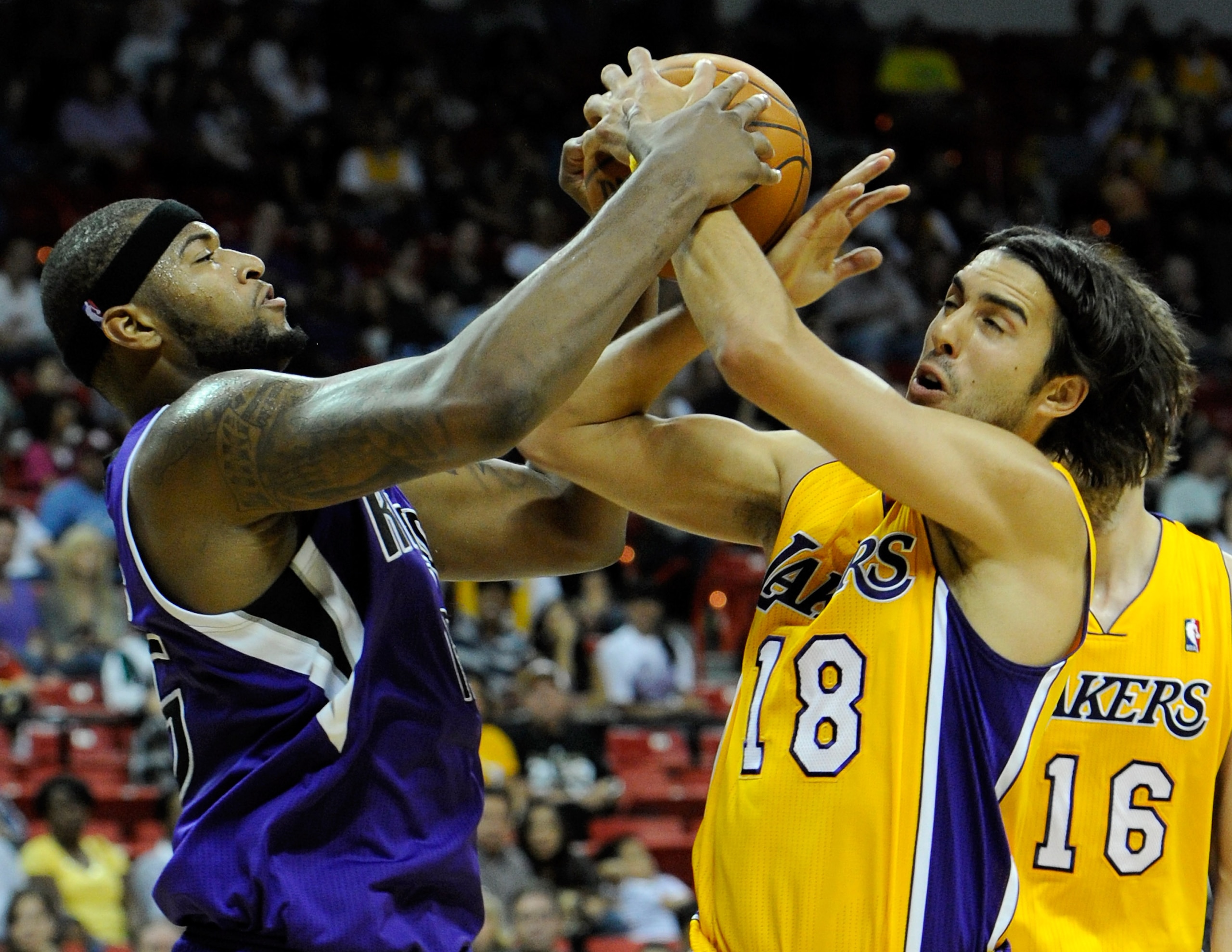 LAS VEGAS - OCTOBER 13:  DeMarcus Cousins #15 of the Sacramento Kings and Sasha Vujacic #18 of the Los Angeles Lakers fight for a rebound during their preseason game at the Thomas & Mack Center October 13, 2010 in Las Vegas, Nevada. The Lakers won 98-95.