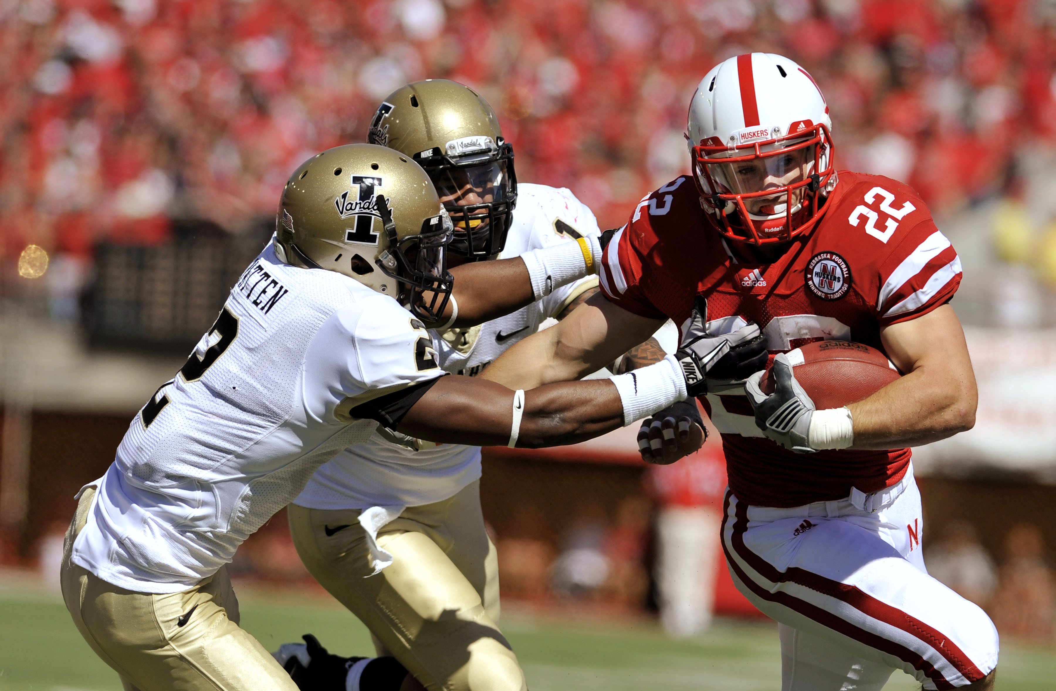 LINCOLN, NE - SEPTEMBER 11: Nebraska Cornhuskers running back Rex Burkhead #22 tries to elude Idaho Vandals cornerback Kenneth Patten #2 and Robert Siavii #1 during first half action of their game at Memorial Stadium on September 4, 2010 in Lincoln, Nebra LINCOLN, NE - SEPTEMBER 11: Nebraska Cornhuskers running back Rex Burkhead #22 tries to elude Idaho Vandals cornerback Kenneth Patten #2 and Robert Siavii #1 during first half action of their game at Memorial Stadium on September 4, 2010 in Lincoln, Nebra