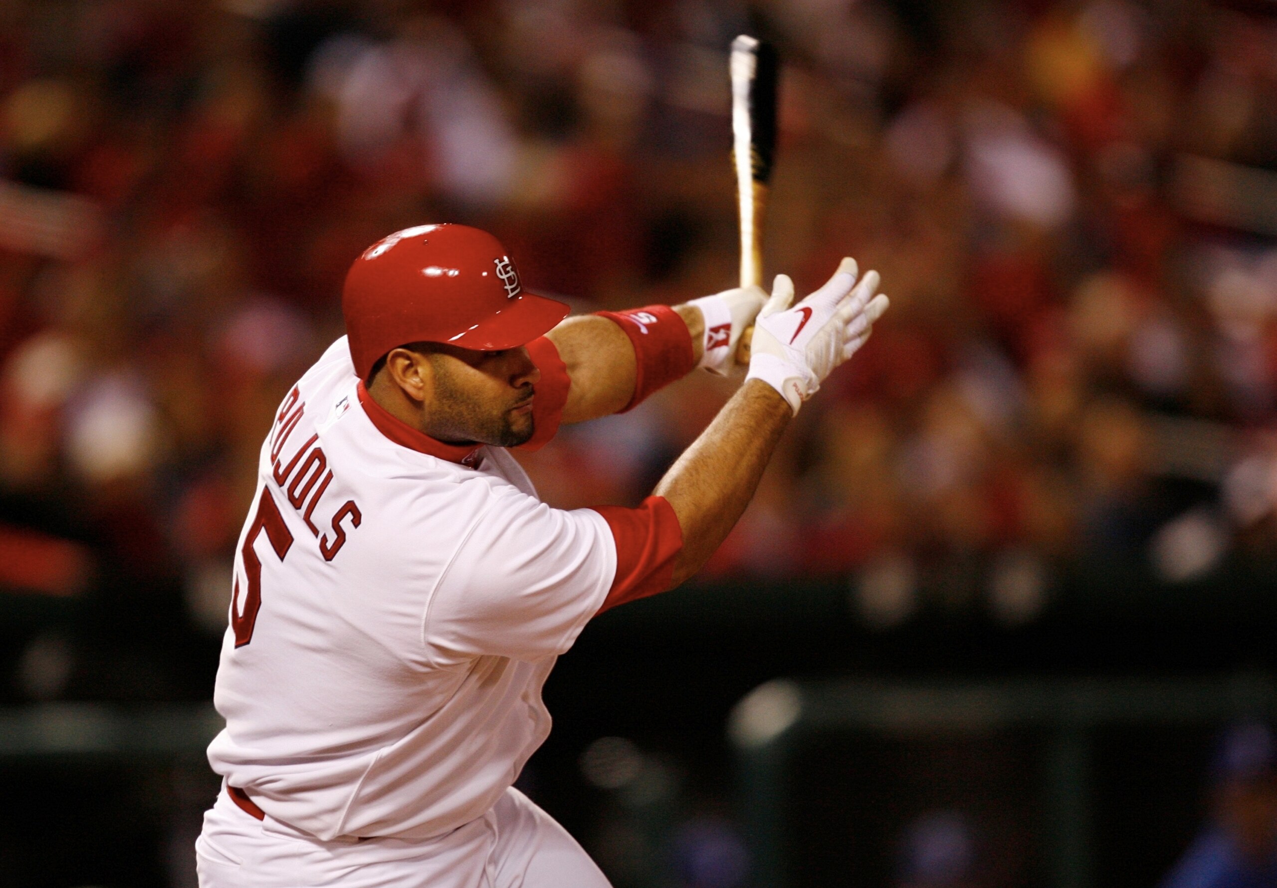 ST. LOUIS, MO - OCTOBER 10:  Albert Pujols #5 of the St. Louis Cardinals hits an RBI single against Los Angeles in the eighth inning of Game Three of the NLDS during the 2009 MLB Playoffs at Busch Stadium on October 10, 2009 in St. Louis, Missouri. (Photo