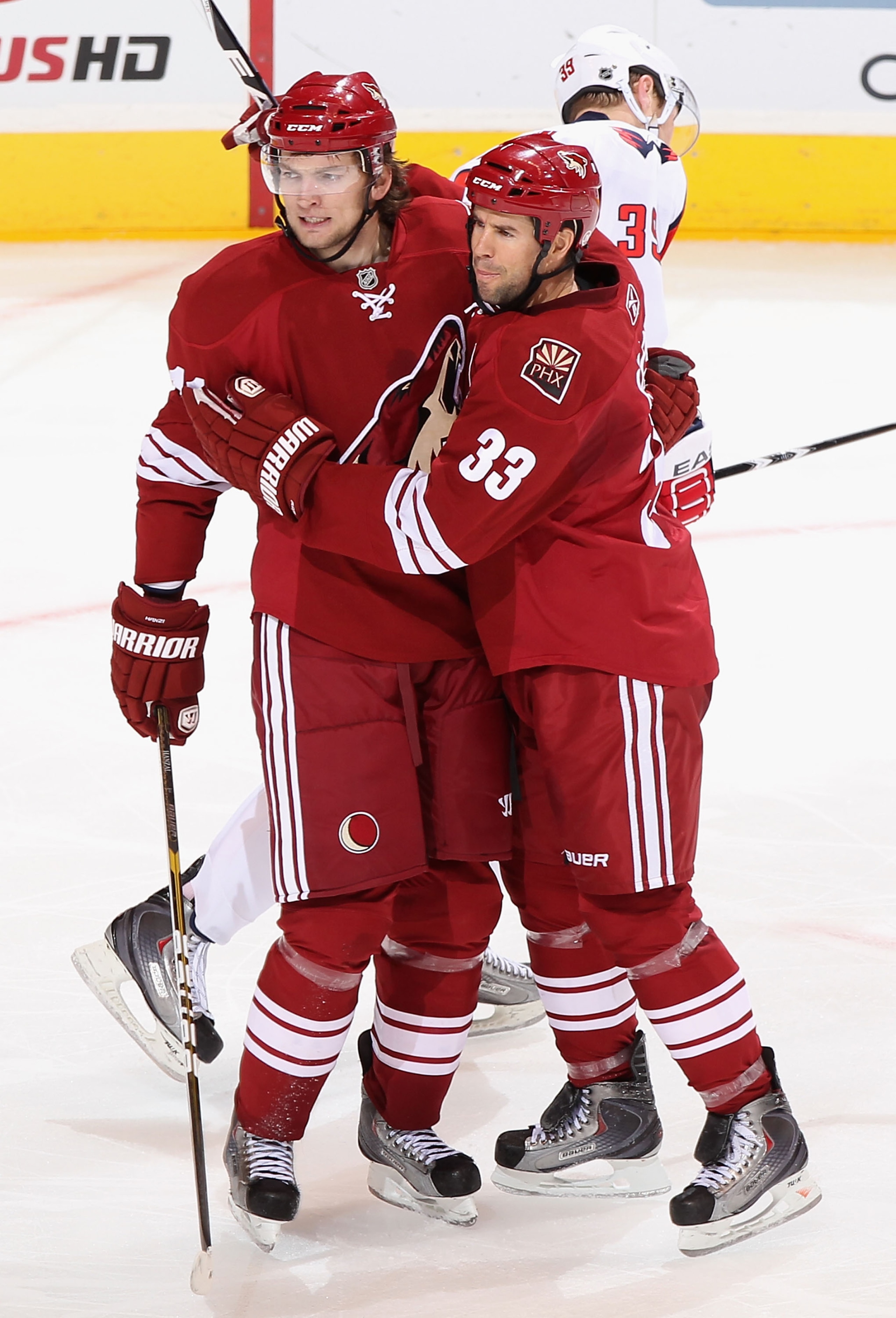 GLENDALE, AZ - FEBRUARY 14:  Martin Hanzal #11 and Adrian Aucoin #33 of the Phoenix Coyotes celebrate after Hanzal scored a second period goal against the Washington Capitals during the NHL game at Jobing.com Arena on February 14, 2011 in Glendale, Arizon