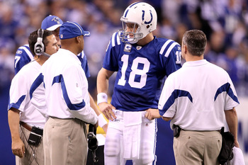 INDIANAPOLIS, IN - JANUARY 08:  Quarterback Peyton Manning #18 of the Indianapolis Colts talks with head coach Jim Caldwell against the New York Jets during their 2011 AFC wild card playoff game at Lucas Oil Stadium on January 8, 2011 in Indianapolis, Ind
