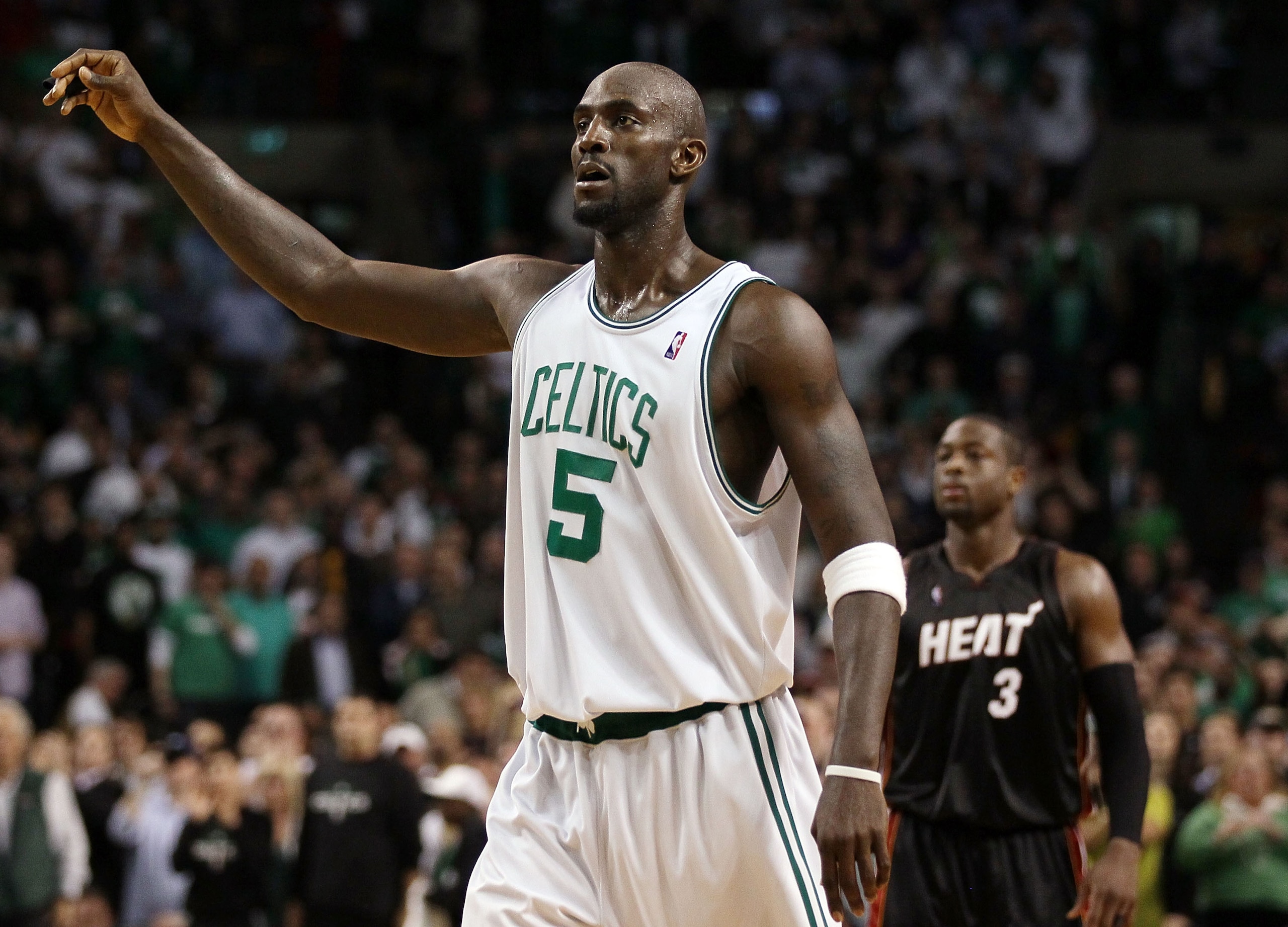 BOSTON - APRIL 27:  Kevin Garnett #5 of the Boston Celtics celebrates at the buzzer as Dwyane Wade #3 of the Miami Heat looks on during Game Five of the Eastern Conference Quarterfinals of the 2010 NBA playoffs at the TD Garden on April 27, 2010 in Boston