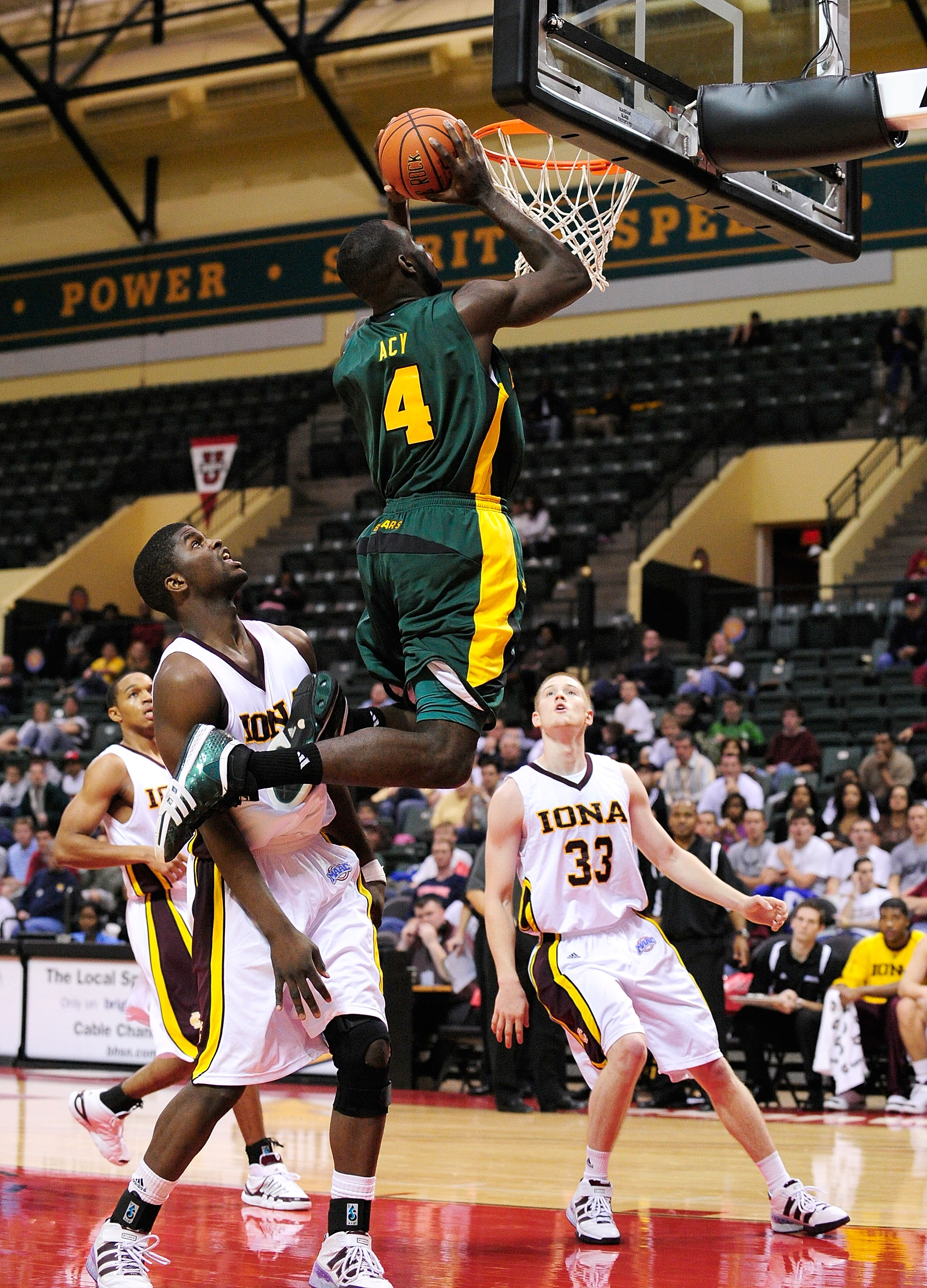ORLANDO, FL - NOVEMBER 27: Quincy Acy #4 of the Baylor Bears attempts a shot against Rashard McGiill #23 of the Iona Gaels during the Old Spice Classic at Disney's Milk House on November 27, 2009 in Orlando, Florida. (Photo by Sam Greenwood/Getty Images