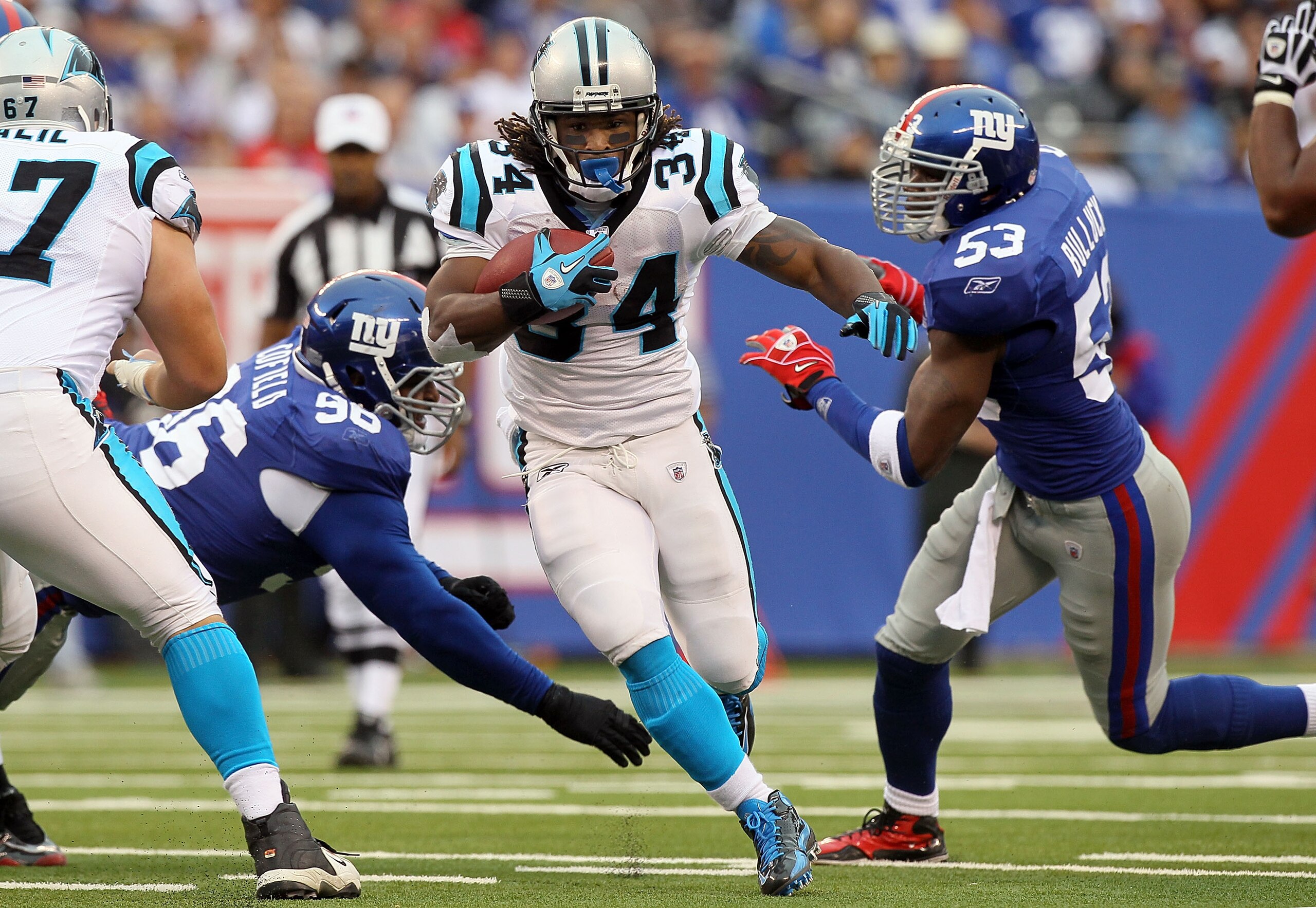 EAST RUTHERFORD, NJ - SEPTEMBER 12:  DeAngelo Williams #34 of the Carolina Panthers runs the ball in the first half against the New York Giants on September 12, 2010 at the New Meadowlands Stadium in East Rutherford, New Jersey.  (Photo by Jim McIsaac/Get