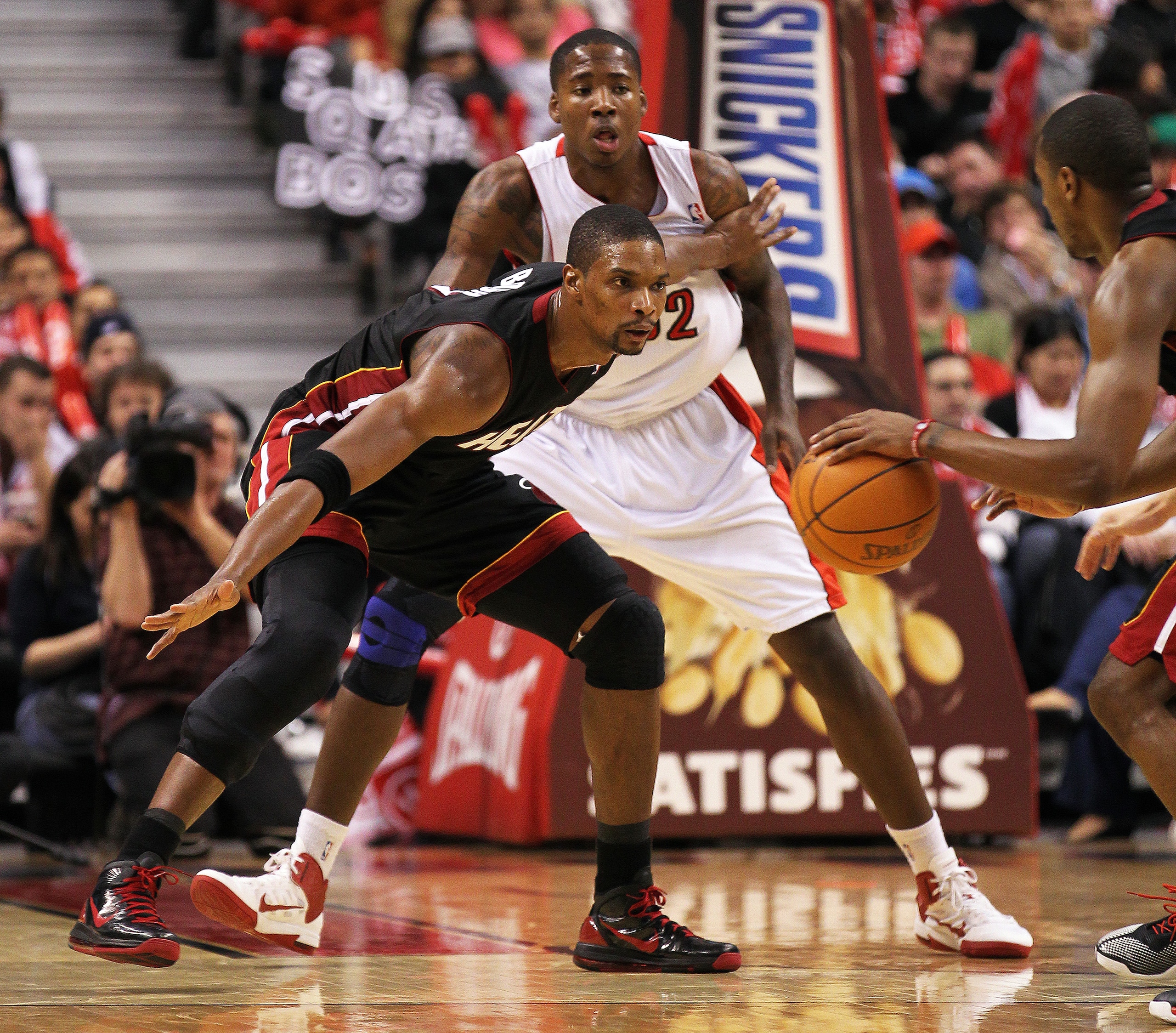 TORONTO, CAN - FEBRUARY 16:  Chris Bosh #1 of the Miami Heat plays a block against Ed Davis #32 of the Toronto Raptors in a game on February 16, 2011 at the Air Canada Centre in Toronto, Canada. The Heat defeated the Raptors 103-95. (Photo by Claus Anders