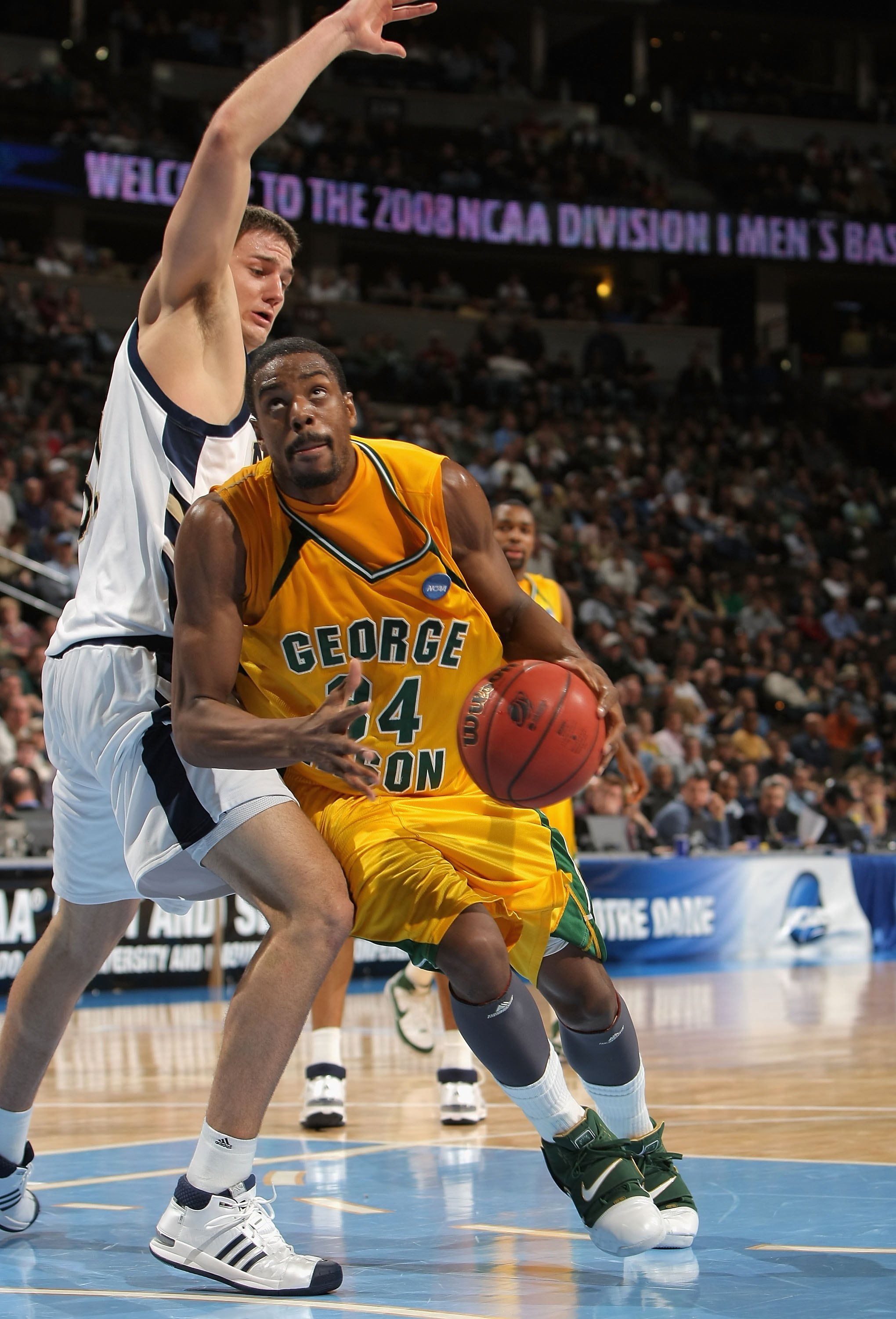 DENVER - MARCH 20: Will Thomas #34 of the George Mason Patriots drives to the basket against the Notre Dame Fighting Irish during the first round of the East Regional as part of the 2008 NCAA Men's Basketball Tournament at Pepsi Center on March 20, 2008