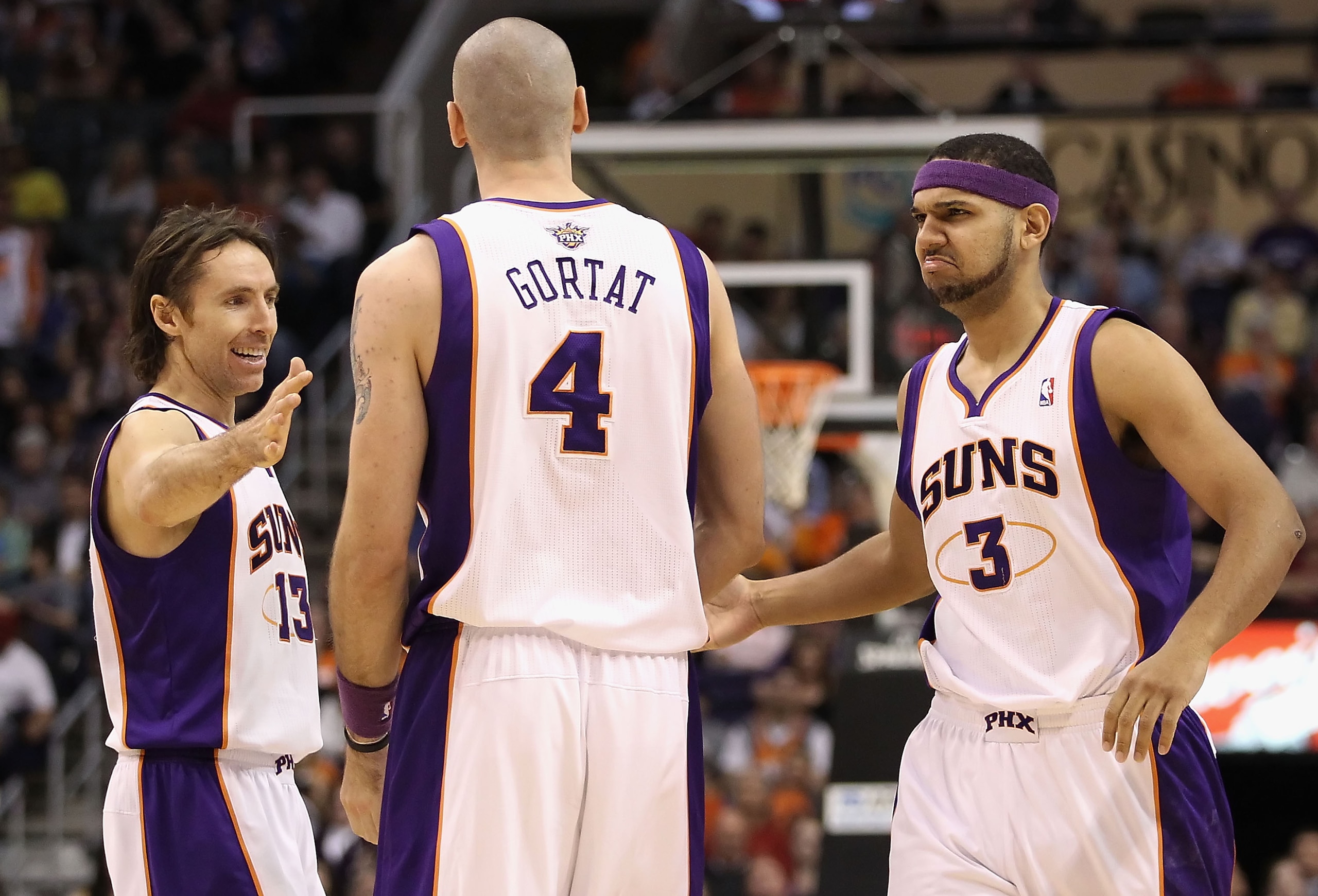 PHOENIX, AZ - JANUARY 30:  (L-R) Steve Nash #13, Marcin Gortat #4 and Jared Dudley #3 of the Phoenix Suns celebrate after scoring against the New Orleans Hornets during the NBA game at US Airways Center on January 30, 2011 in Phoenix, Arizona.  The Suns d