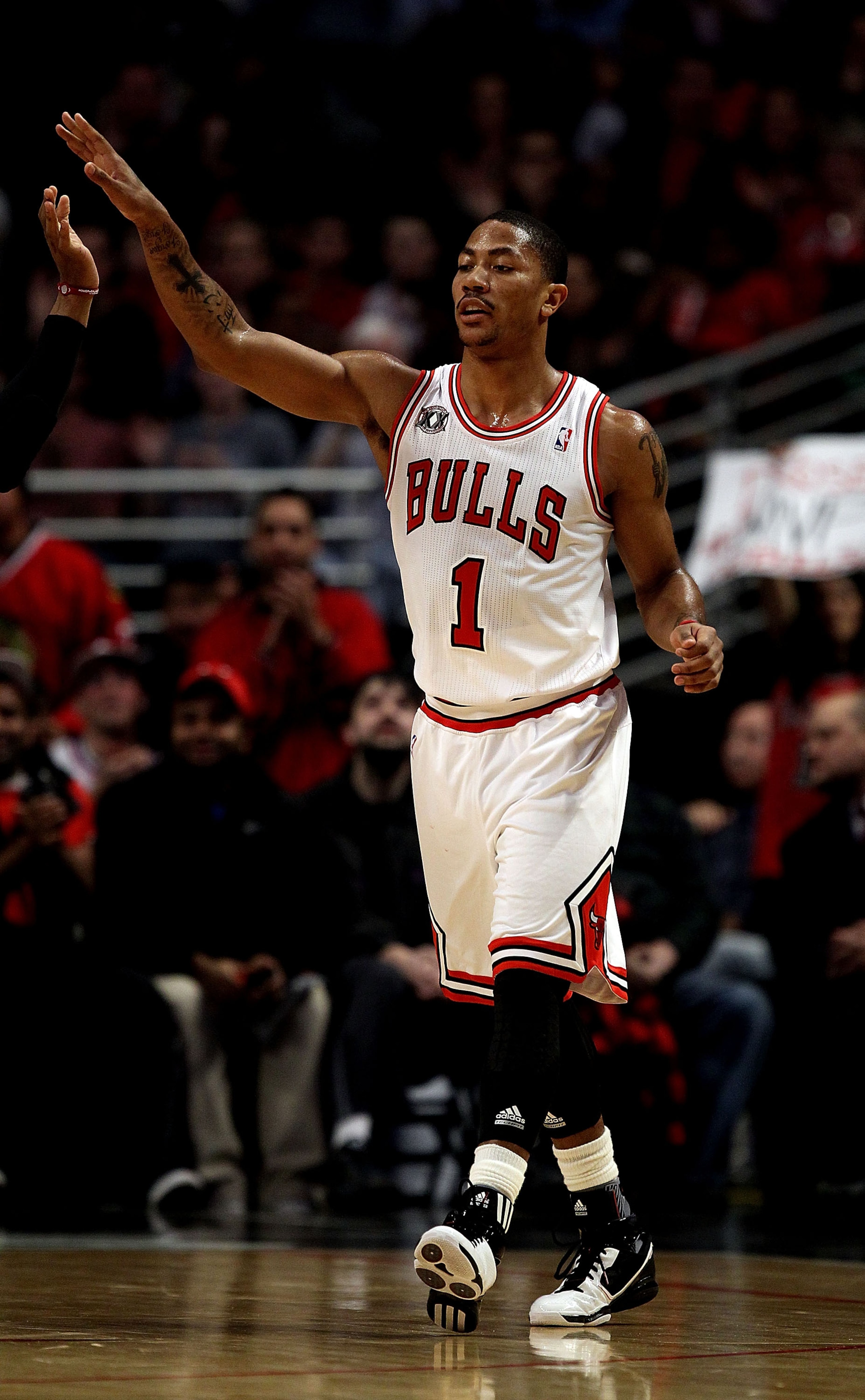 CHICAGO, IL - FEBRUARY 17: Derrick Rose #1 of the Chicago Bulls celebrates with a teammate during a game against the San Antonio Spurs at the United Center on February 17, 2011 in Chicago, Illinois. The Bulls defeated the Spurs 109-99. NOTE TO USER: User 