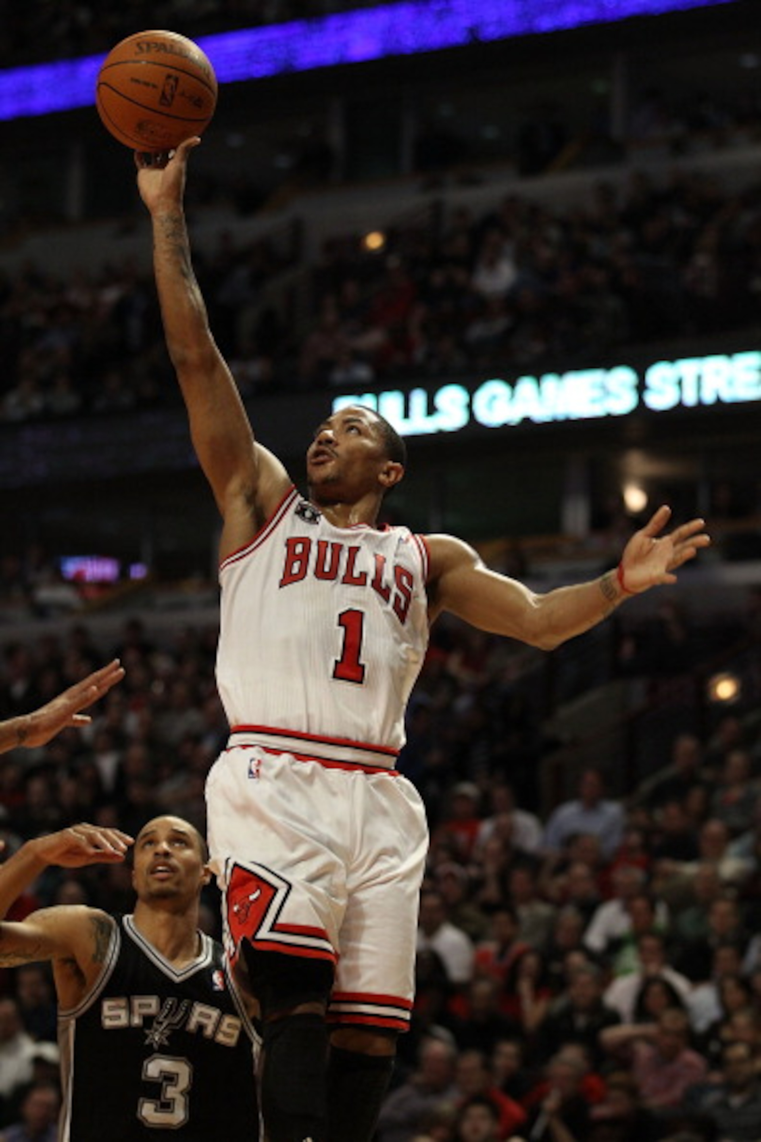 CHICAGO, IL - FEBRUARY 17: Derrick Rose #1 of the Chicago Bulls goes up for a shot past George Hill #3 of the San Antonio Spurs on his way to a game and career high 42 points at the United Center on February 17, 2011 in Chicago, Illinois. The Bulls defeat