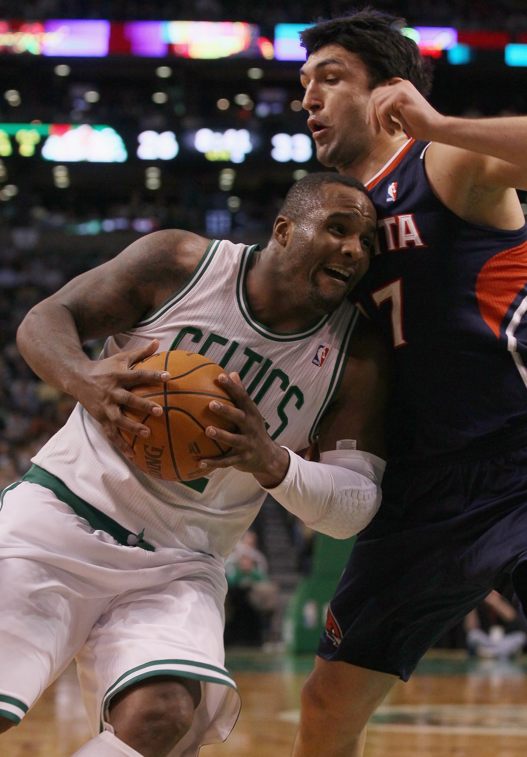 BOSTON, MA - DECEMBER 16:  Glen Davis #11 of the Boston Celtics drives to the net as Zaza Pachulia #27  of the Atlanta Hawks defends on December 16, 2010 at the TD Garden in Boston, Massachusetts. NOTE TO USER: User expressly acknowledges and agrees that,