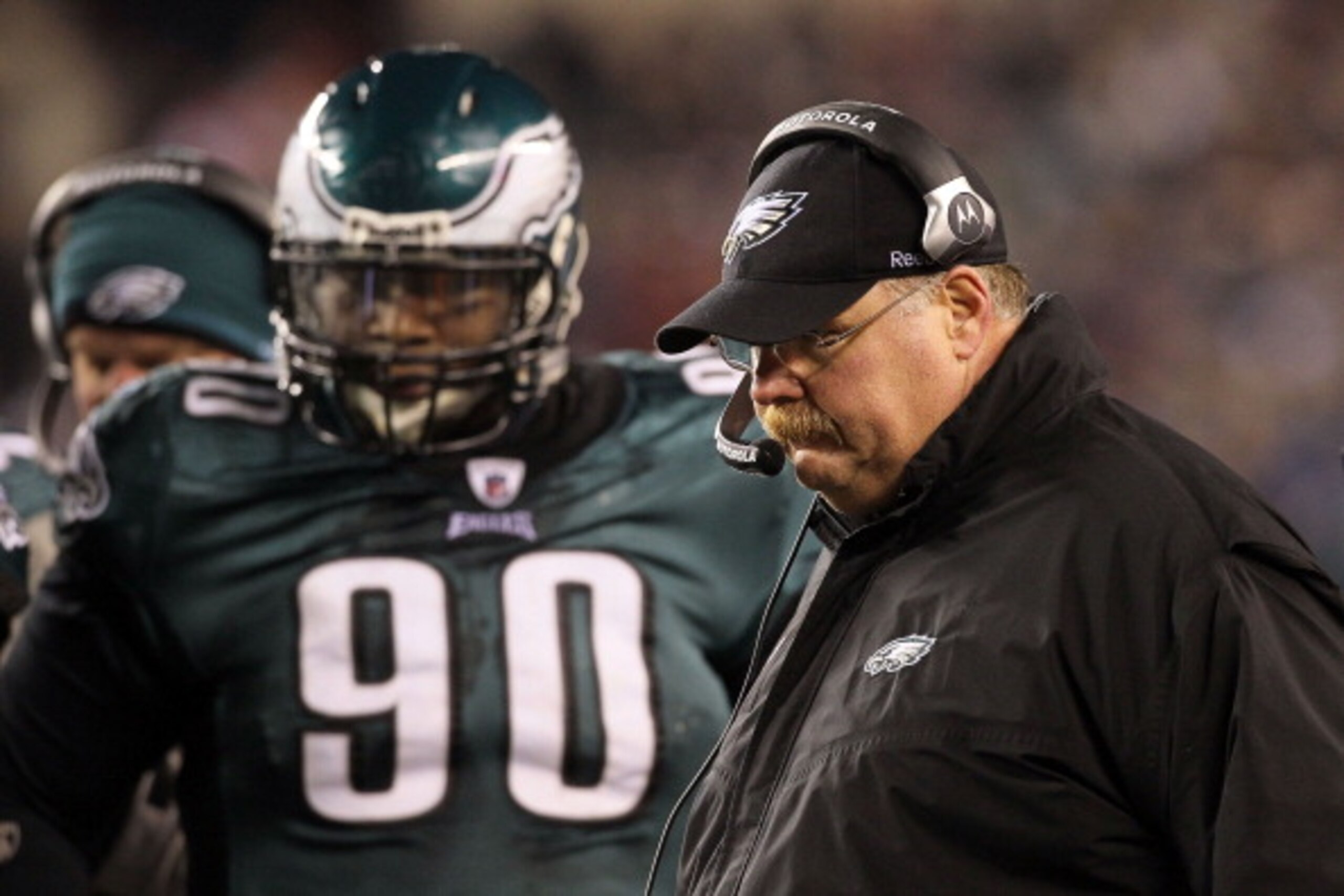 PHILADELPHIA, PA - DECEMBER 28: Head Coach Andy Reid (R) of the Philadelphia Eagles stands on the sidelines with Antonio Dixon #90 during their game against the Minnesota Vikings at Lincoln Financial Field on December 28, 2010 in Philadelphia, Pennsylvani