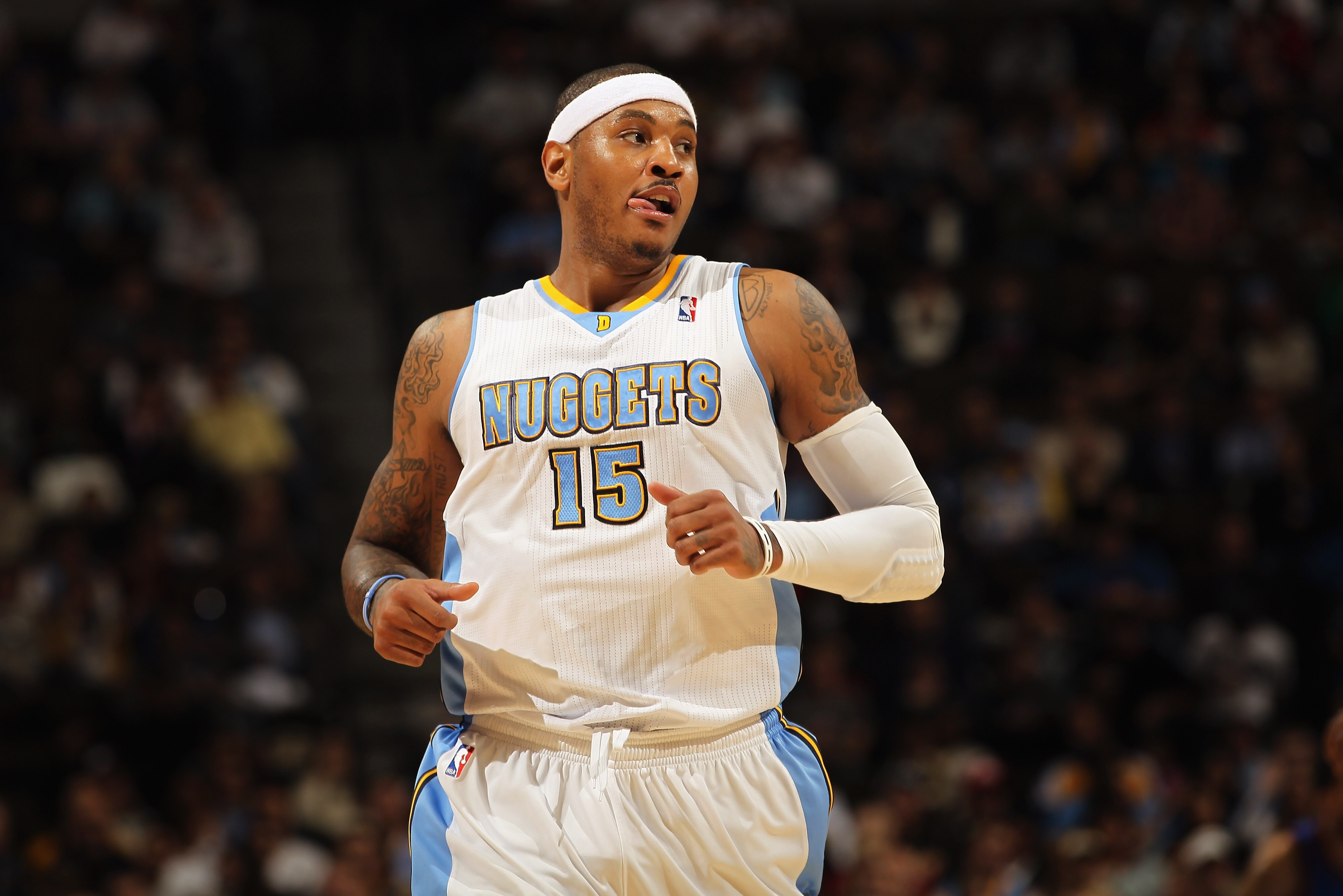 DENVER - NOVEMBER 16:  Carmelo Anthony #15 of the Denver Nuggets looks on during a break in the action against the New York Knicks at the Pepsi Center on November 16, 2010 in Denver, Colorado. The Nuggets defeated the Knicks 120-118. NOTE TO USER: User ex
