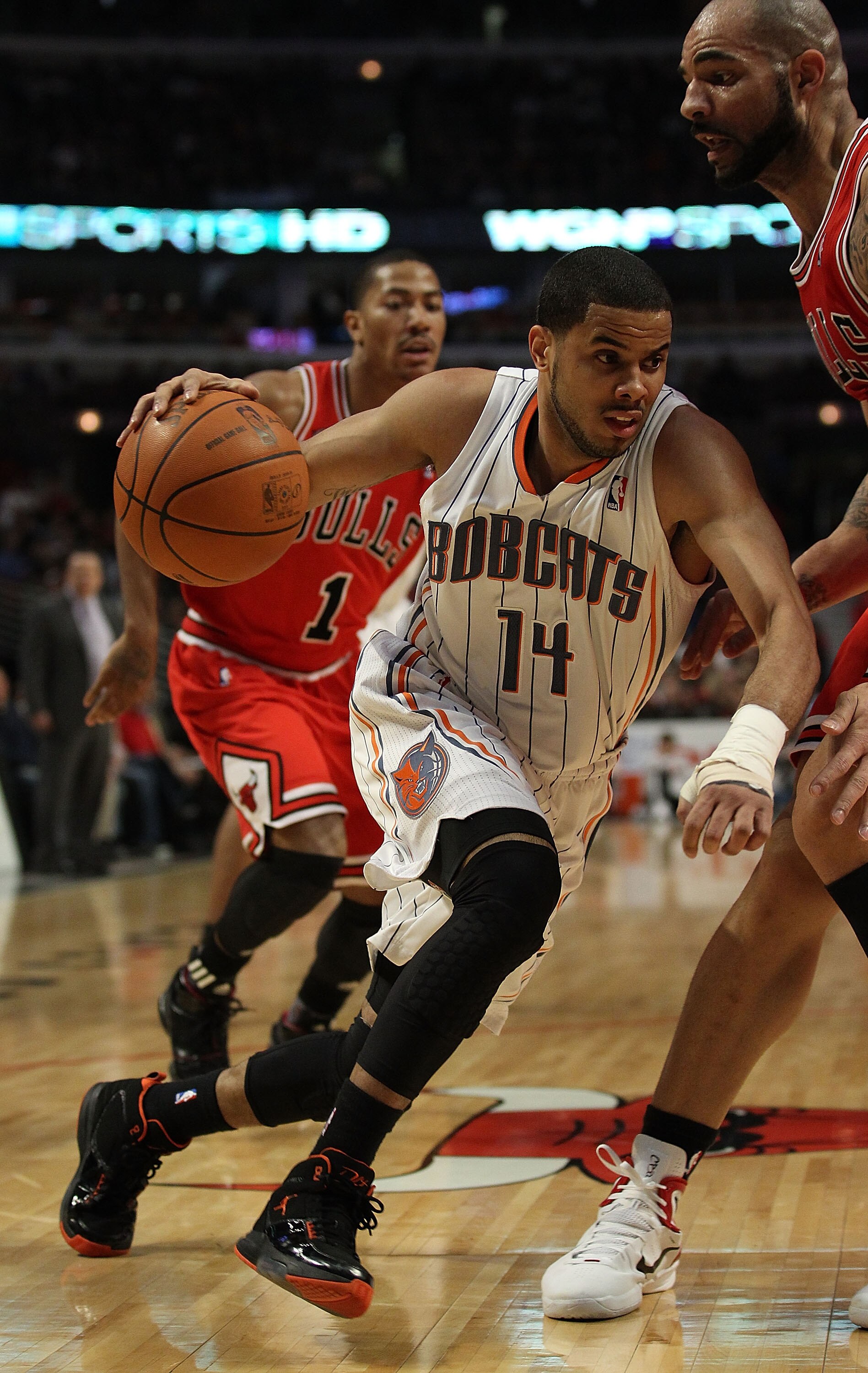 CHICAGO, IL - FEBRUARY 15: D.J. Augustin #14 of the Charlotte Bobcats moves against Carlos Boozer #5 of the Chicago Bulls at the United Center on February 15, 2011 in Chicago, Illinois. The Bulls defeated the Bobcats 106-94. NOTE TO USER: User expressly a