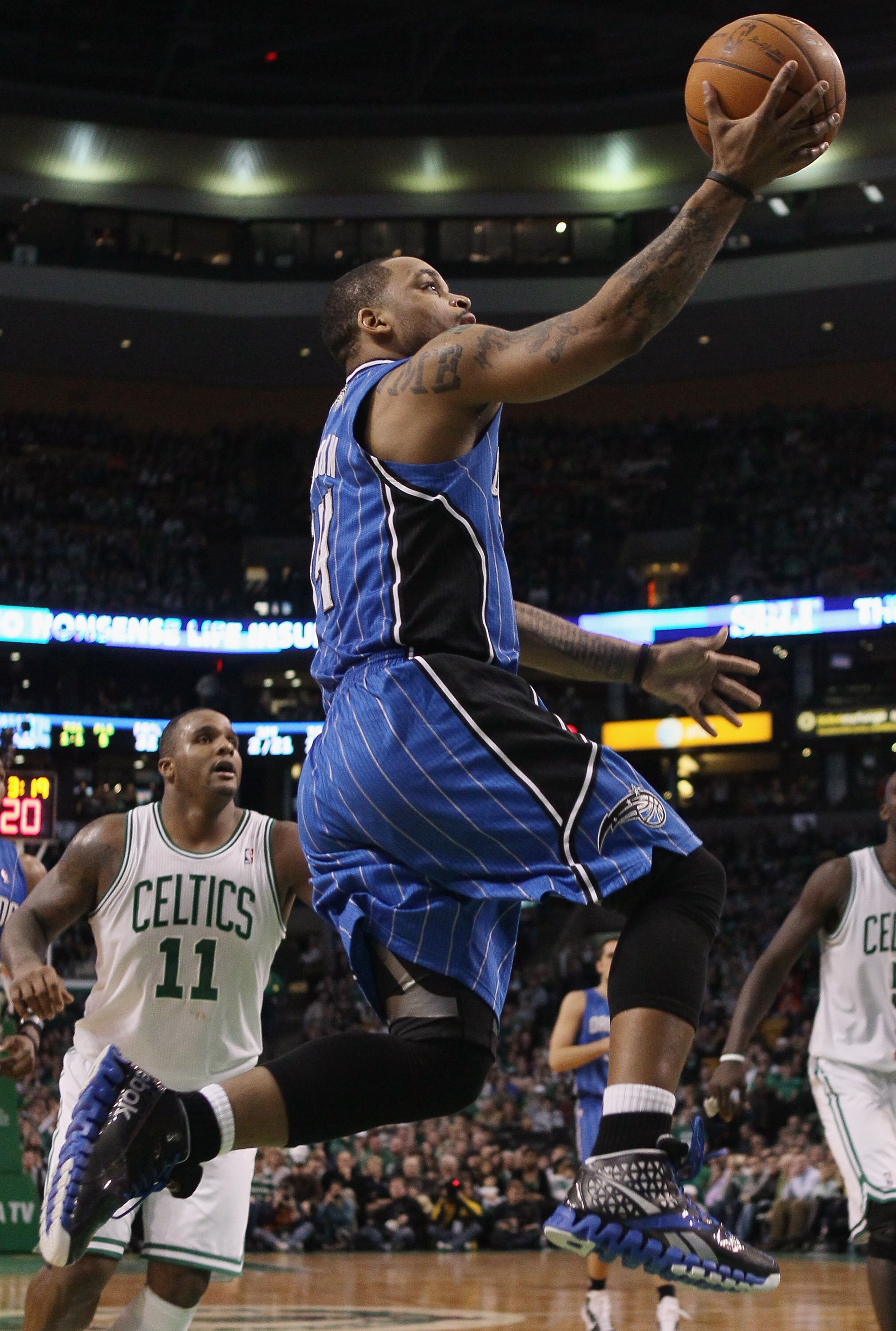 BOSTON, MA - FEBRUARY 06:  Jameer Nelson #14 of the Orlando Magic heads for the basket past Glen Davis #11 of the Boston Celtics on February 6, 2011 at the TD Garden in Boston, Massachusetts. The Celtics defeated the Magic 91-80. NOTE TO USER: User expres
