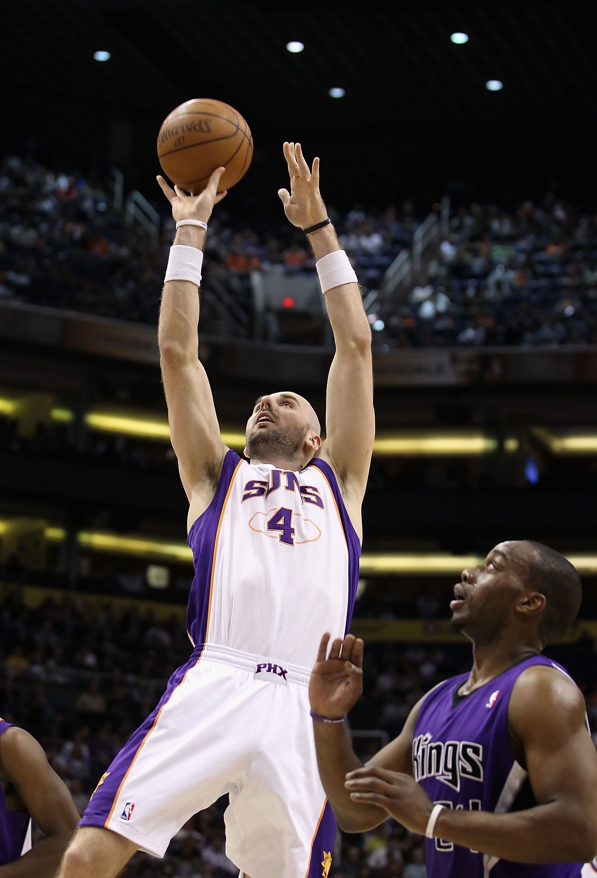 PHOENIX, AZ - FEBRUARY 13:  Marcin Gortat #4 of the Phoenix Suns attempts a shot against the Sacramento Kings during the NBA game at US Airways Center on February 13, 2011 in Phoenix, Arizona. The Kings defeated the Suns 113-108.  NOTE TO USER: User expre