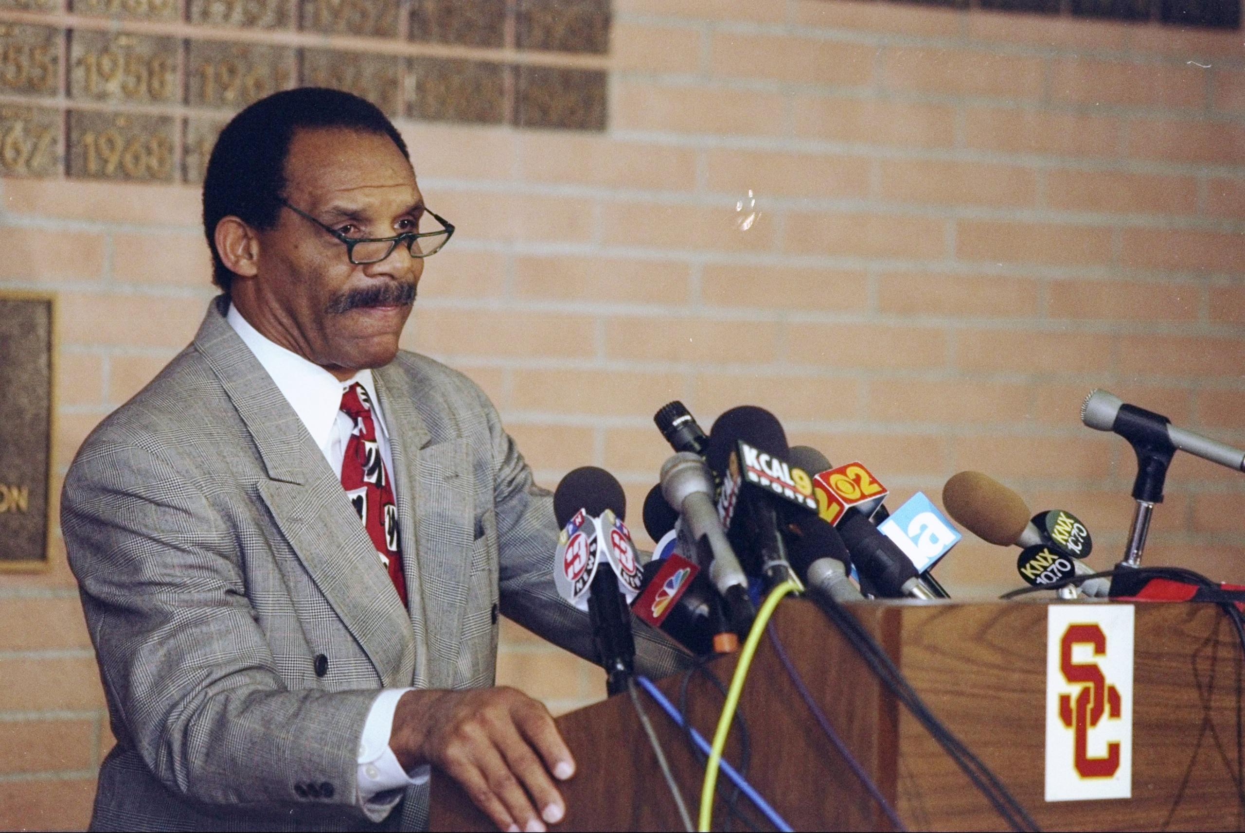 17 Dec 1997: Athletic Director Mike Garrett of USC talks at a press conference after the firing of head coach John Robinson of the USC Trojans football staff at the Sheraton Grande Hotel in Los Angeles, California. 17 Dec 1997: Athletic Director Mike Garrett of USC talks at a press conference after the firing of head coach John Robinson of the USC Trojans football staff at the Sheraton Grande Hotel in Los Angeles, California.