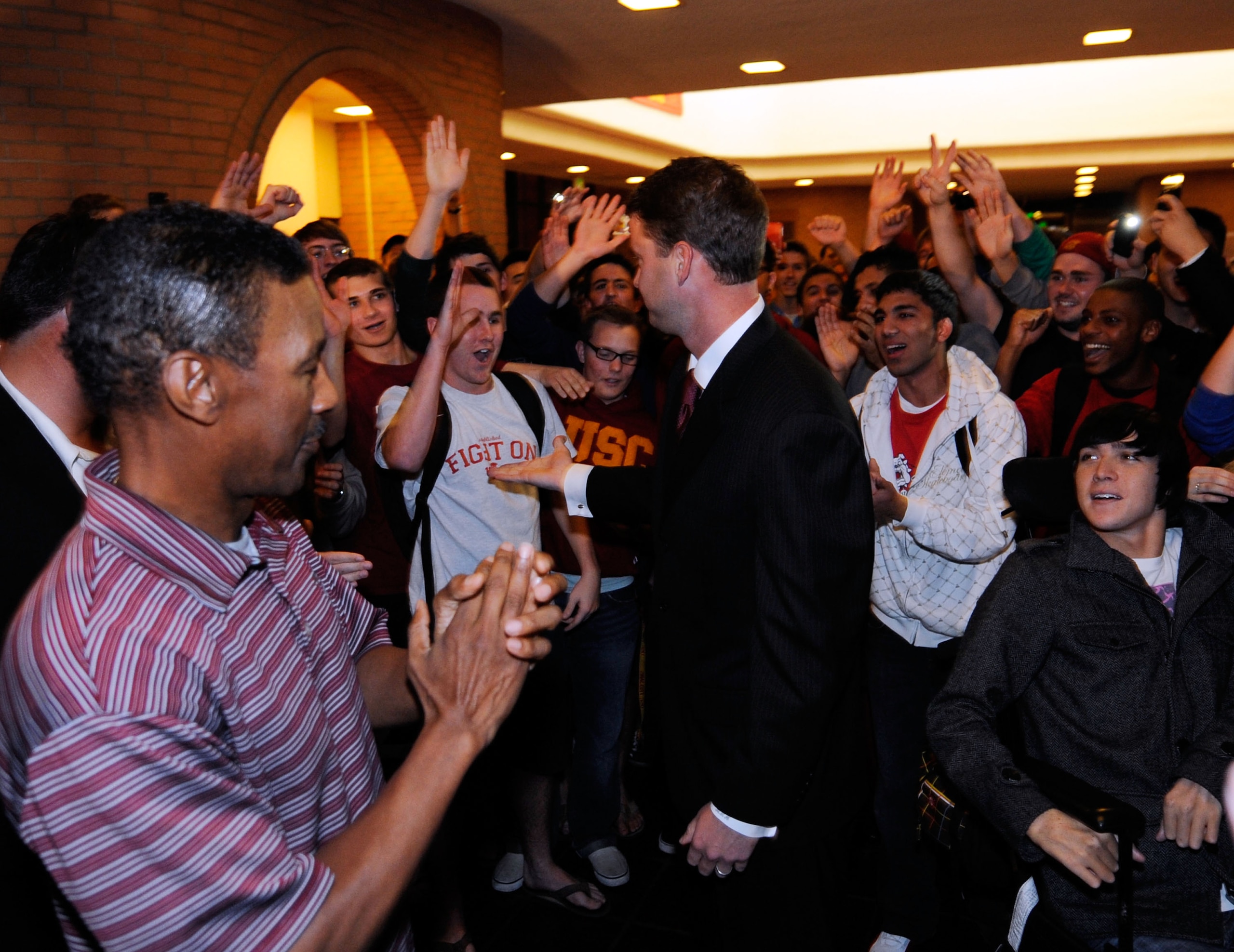 LOS ANGELES, CA - JANUARY 13:  Lane Kiffin the new college football coach of University of Southern California greets students as he arrives for a news conference at Heritage Hall on the campus of USC on January 13, 2010 in Los Angeles, California.  (Phot