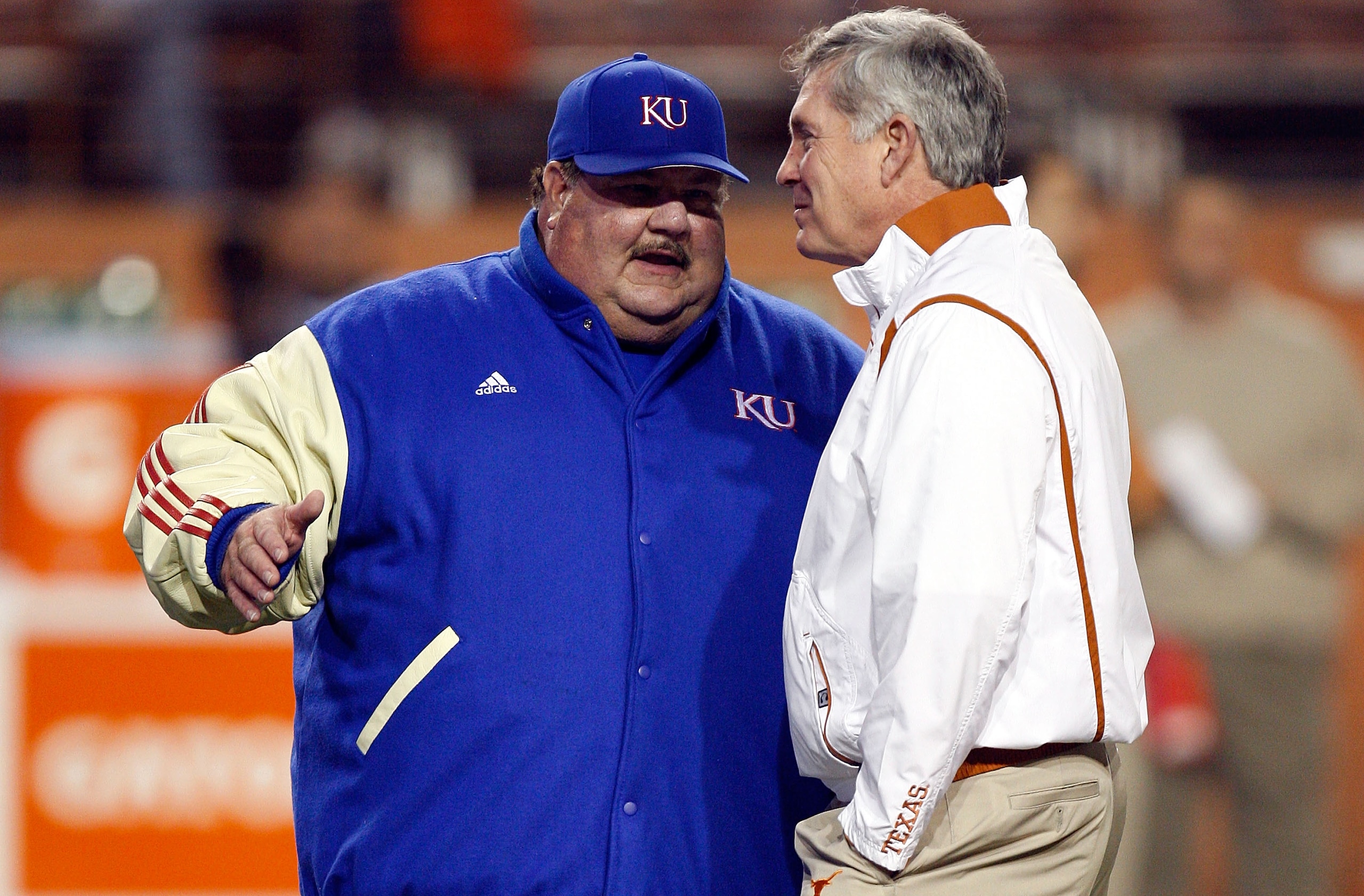 AUSTIN, TX - NOVEMBER 21: Head coach Mark Mangino of the Kansas Jayhawks talks with Mack Brown of the Texas Longhorns at Darrell K Royal-Texas Memorial Stadium on November 21, 2009 in Austin, Texas. (Photo by Ronald Martinez/Getty Images) AUSTIN, TX - NOVEMBER 21: Head coach Mark Mangino of the Kansas Jayhawks talks with Mack Brown of the Texas Longhorns at Darrell K Royal-Texas Memorial Stadium on November 21, 2009 in Austin, Texas. (Photo by Ronald Martinez/Getty Images)