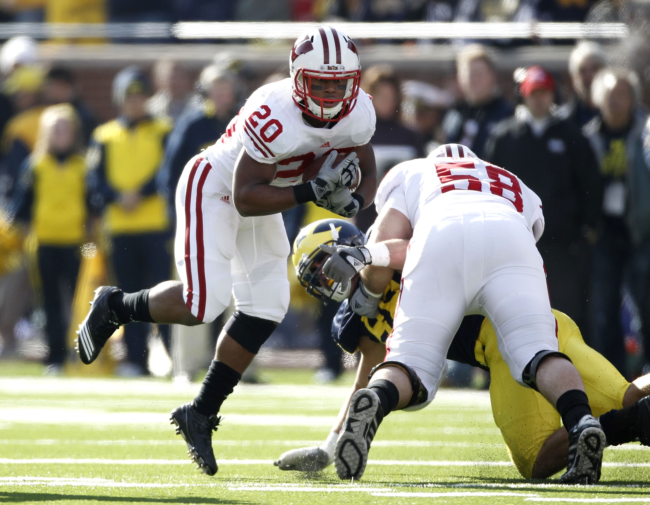 ANN ARBOR, MI - NOVEMBER 20: James White #20 of the Wisconsin Badgers jumps arond the block of teammate Ricky Wagner #58 while playing the Michigan Wolverines at Michigan Stadium on November 20, 2010 in Ann Arbor, Michigan. (Photo by Gregory Shamus/Getty ANN ARBOR, MI - NOVEMBER 20: James White #20 of the Wisconsin Badgers jumps arond the block of teammate Ricky Wagner #58 while playing the Michigan Wolverines at Michigan Stadium on November 20, 2010 in Ann Arbor, Michigan. (Photo by Gregory Shamus/Getty