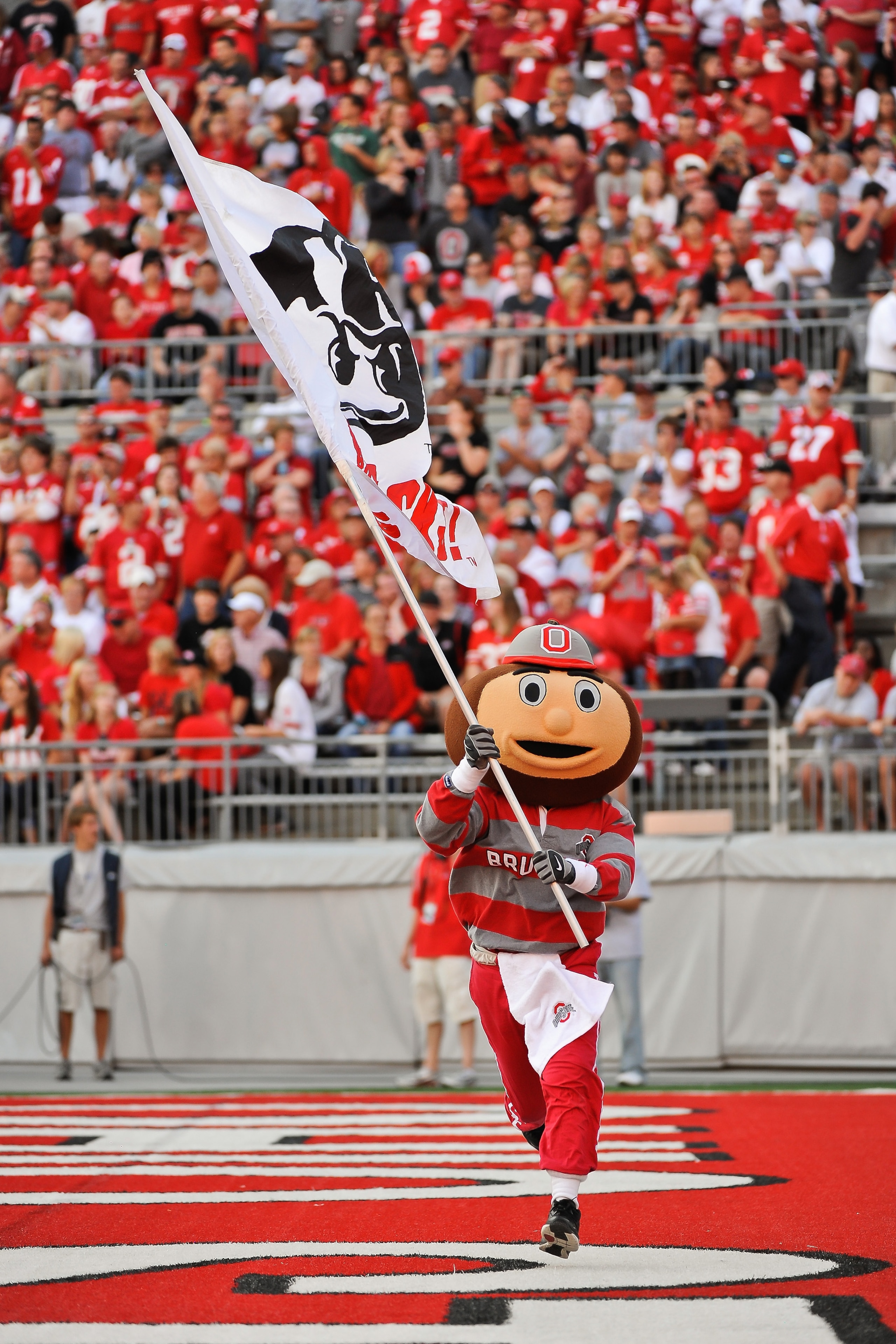 COLUMBUS, OH - SEPTEMBER 25: Ohio State Buckeyes mascot Brutus Buckeye carries a flag during a game against the Eastern Michigan Eagles at Ohio Stadium on September 25, 2010 in Columbus, Ohio. Ohio State won 73-20. (Photo by Jamie Sabau/Getty Images) COLUMBUS, OH - SEPTEMBER 25: Ohio State Buckeyes mascot Brutus Buckeye carries a flag during a game against the Eastern Michigan Eagles at Ohio Stadium on September 25, 2010 in Columbus, Ohio. Ohio State won 73-20. (Photo by Jamie Sabau/Getty Images)