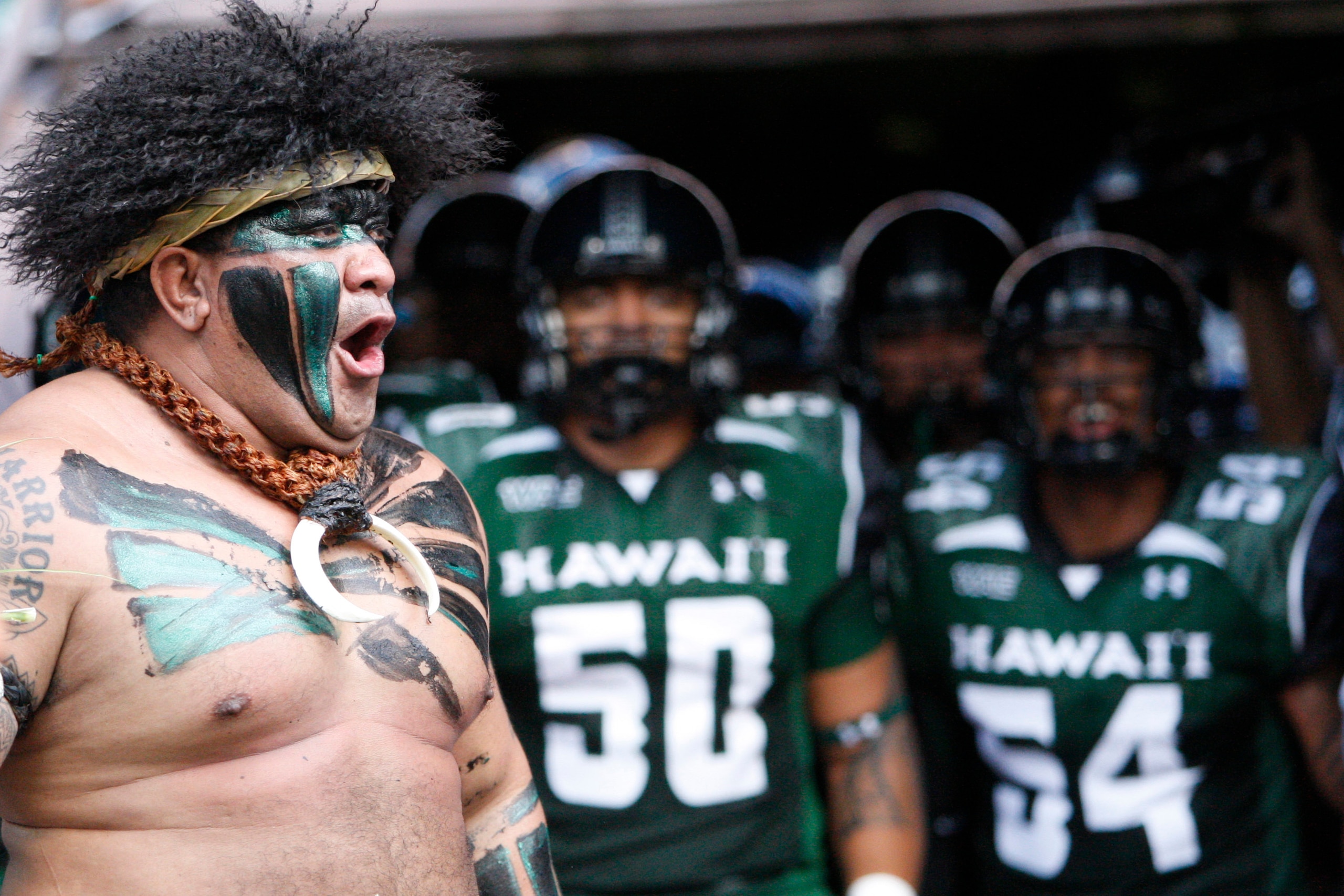 HONOLULU - SEPTEMBER 02: Vili Fehoko, the University of Hawaii Mascot cheers as the University of Hawaii Warriors prepare to take the field in their season opener at Aloha Stadium September 2, 2010 in Honolulu, Hawaii. (Photo by Kent Nishimura/Getty Image HONOLULU - SEPTEMBER 02: Vili Fehoko, the University of Hawaii Mascot cheers as the University of Hawaii Warriors prepare to take the field in their season opener at Aloha Stadium September 2, 2010 in Honolulu, Hawaii. (Photo by Kent Nishimura/Getty Image