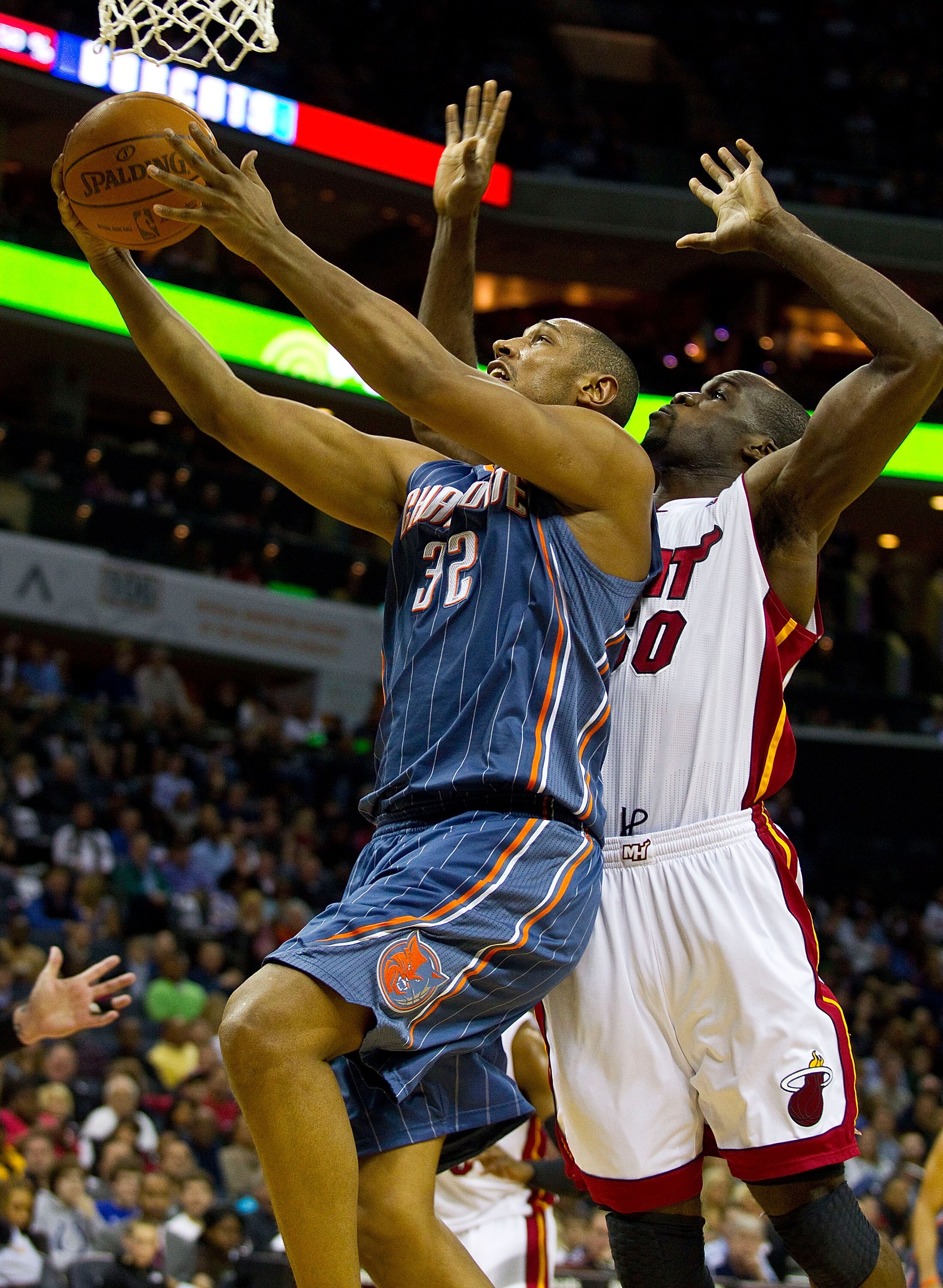 CHARLOTTE, NC - FEBRUARY 04:  Boris Diaw #32 of the Charlotte Bobcats drives to the basket past Joel Anthony #50 of the Miami Heat at the Time Warner Cable Arena on February 4, 2011 in Charlotte, North Carolina.  The Heat defeated the Bobcats 109-97.  NOT