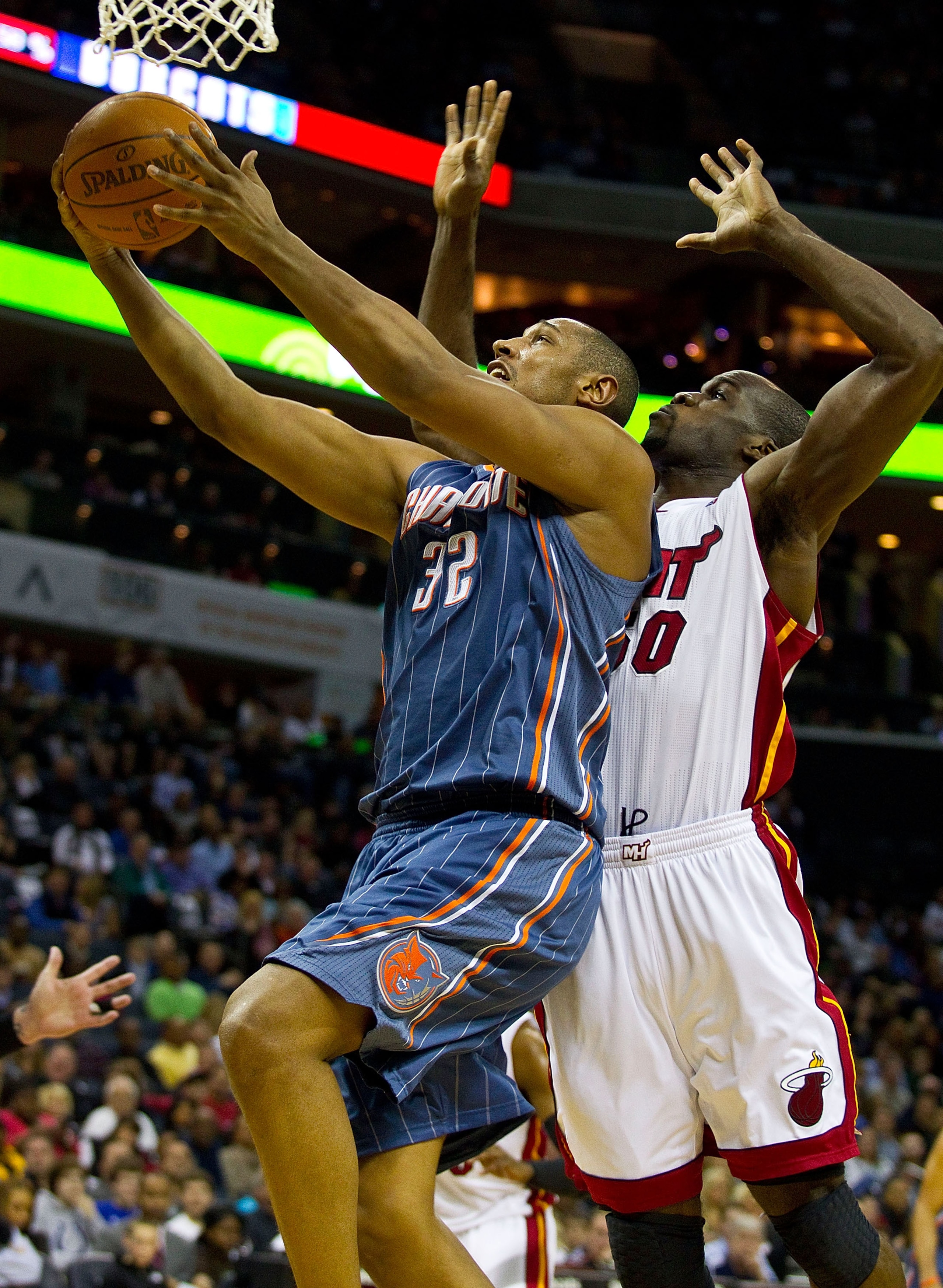 CHARLOTTE, NC - FEBRUARY 04:  Boris Diaw #32 of the Charlotte Bobcats drives to the basket past Joel Anthony #50 of the Miami Heat at the Time Warner Cable Arena on February 4, 2011 in Charlotte, North Carolina.  The Heat defeated the Bobcats 109-97.  NOT
