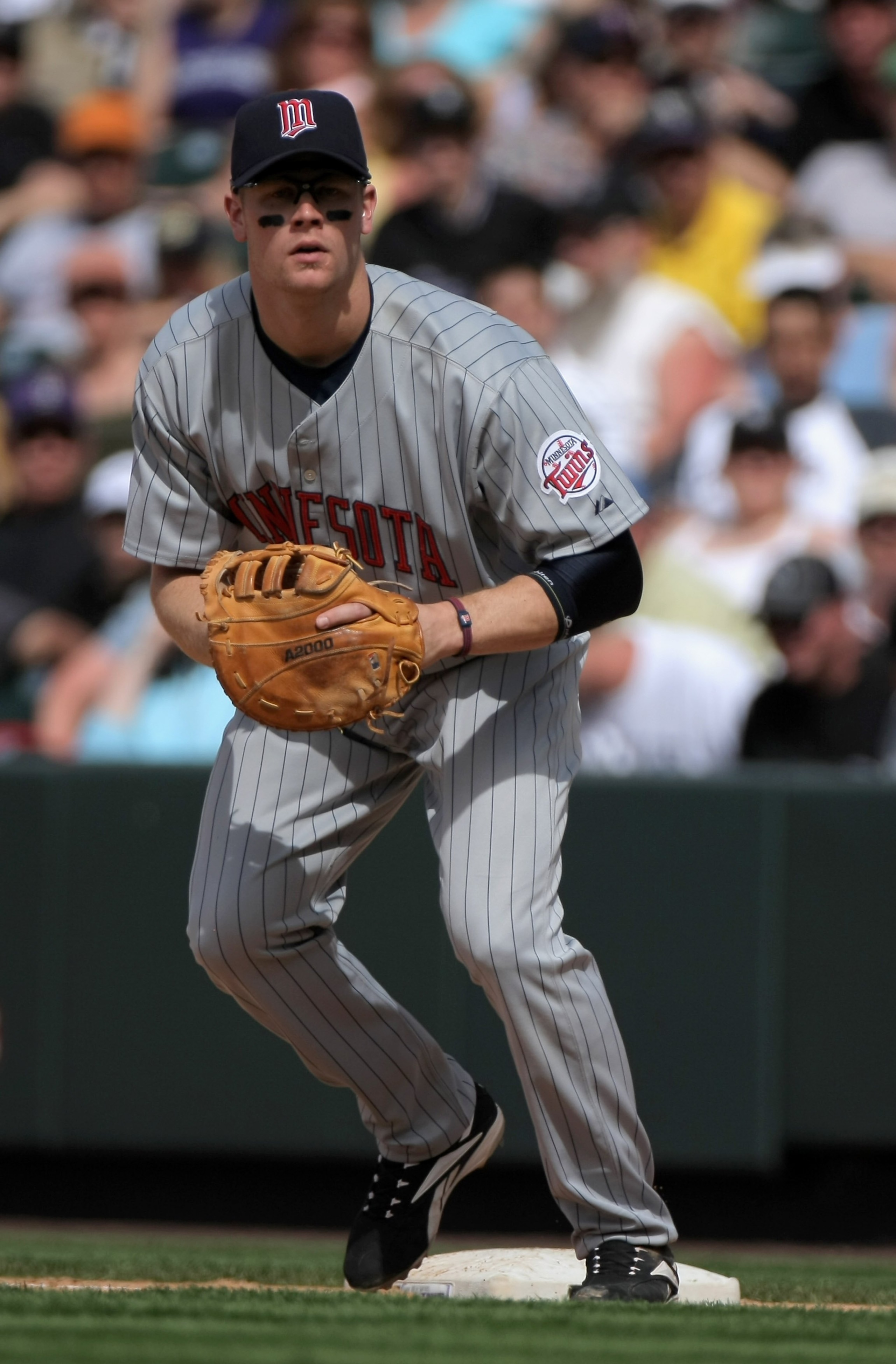 DENVER - MAY 18:  First baseman Justin Morneau #33 of the Minnesota Twins plays defense against the Colorado Rockies during Interleague MLB action at Coors Field on May 18, 2008 in Denver, Colorado. The Rockies defeated the Twins 6-2.  (Photo by Doug Pens