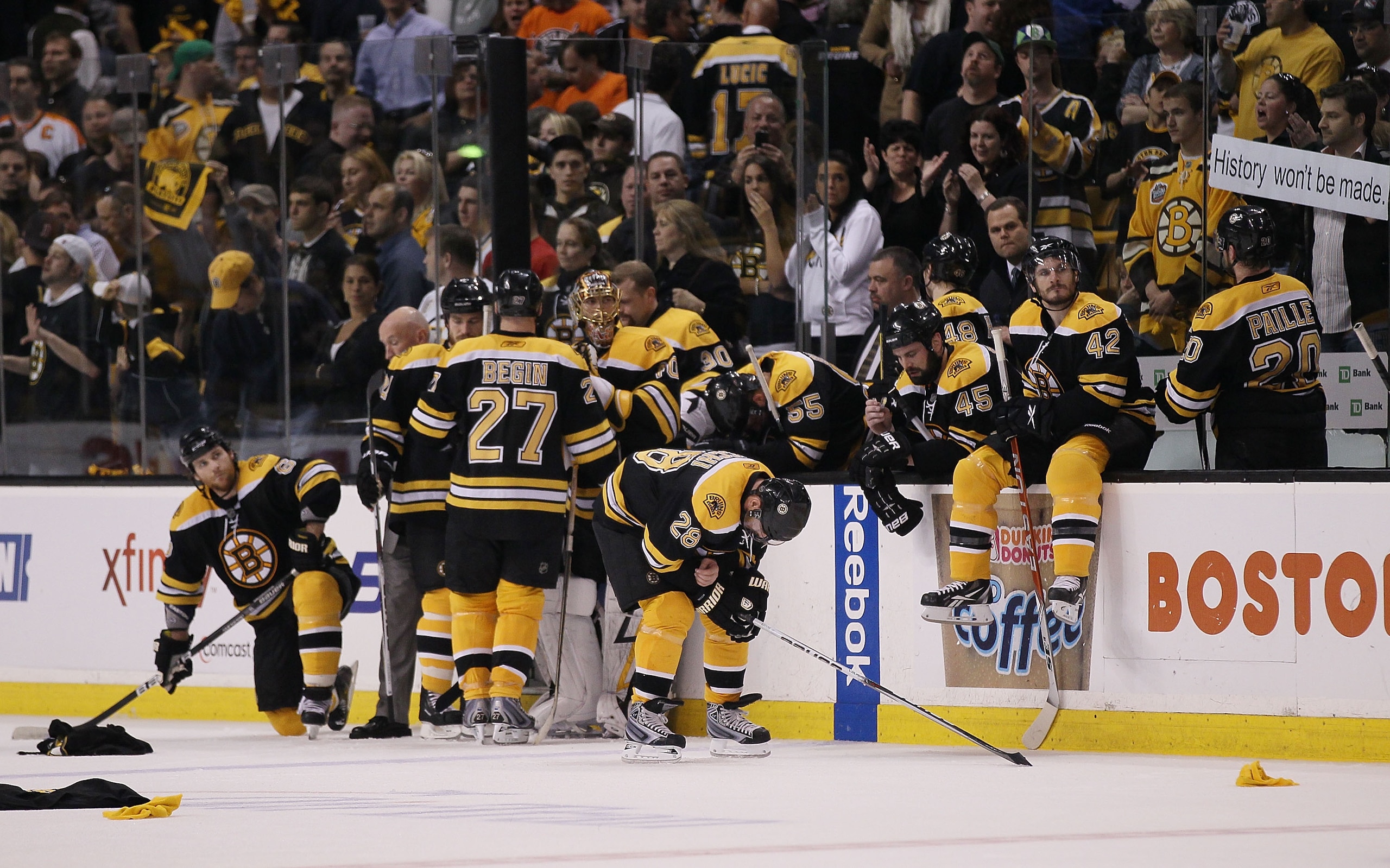 BOSTON - MAY 14: The Boston Bruins sit near their bench as the Philadelphia Flyers celebrate the win in Game Seven of the Eastern Conference Semifinals during the 2010 NHL Stanley Cup Playoffs at TD Garden on May 14, 2010 in Boston, Massachusetts. The F BOSTON - MAY 14: The Boston Bruins sit near their bench as the Philadelphia Flyers celebrate the win in Game Seven of the Eastern Conference Semifinals during the 2010 NHL Stanley Cup Playoffs at TD Garden on May 14, 2010 in Boston, Massachusetts. The F