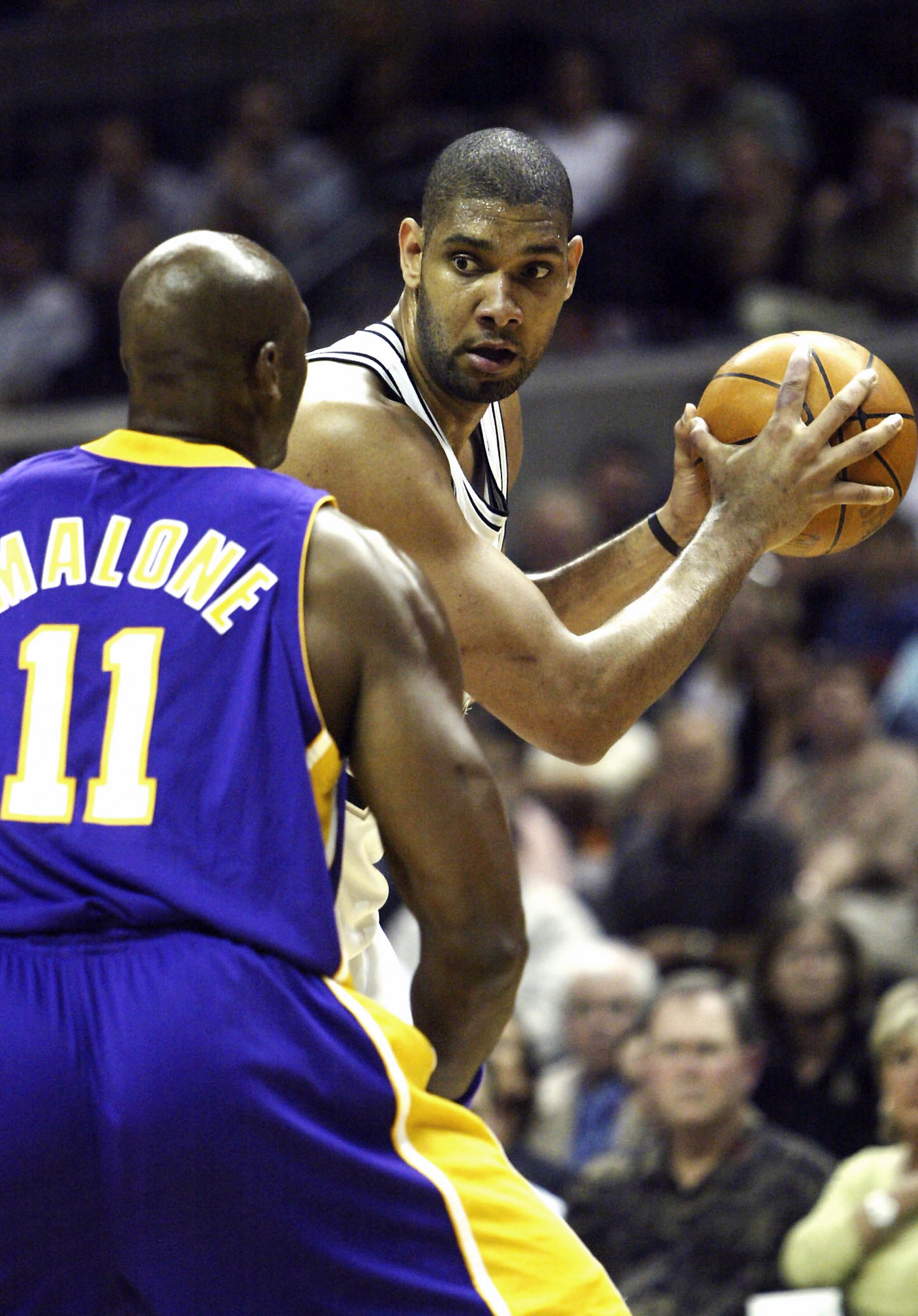 SAN ANTONIO - MAY 2:  Tim Duncan #21 of the San Antonio Spurs tries to create a play defended by Karl Malone #11 of the Los Angeles Lakers during Game one of the Western Conference Semifinals during the 2004 NBA Playoffs on May 2, 2004 at the SBC Center i