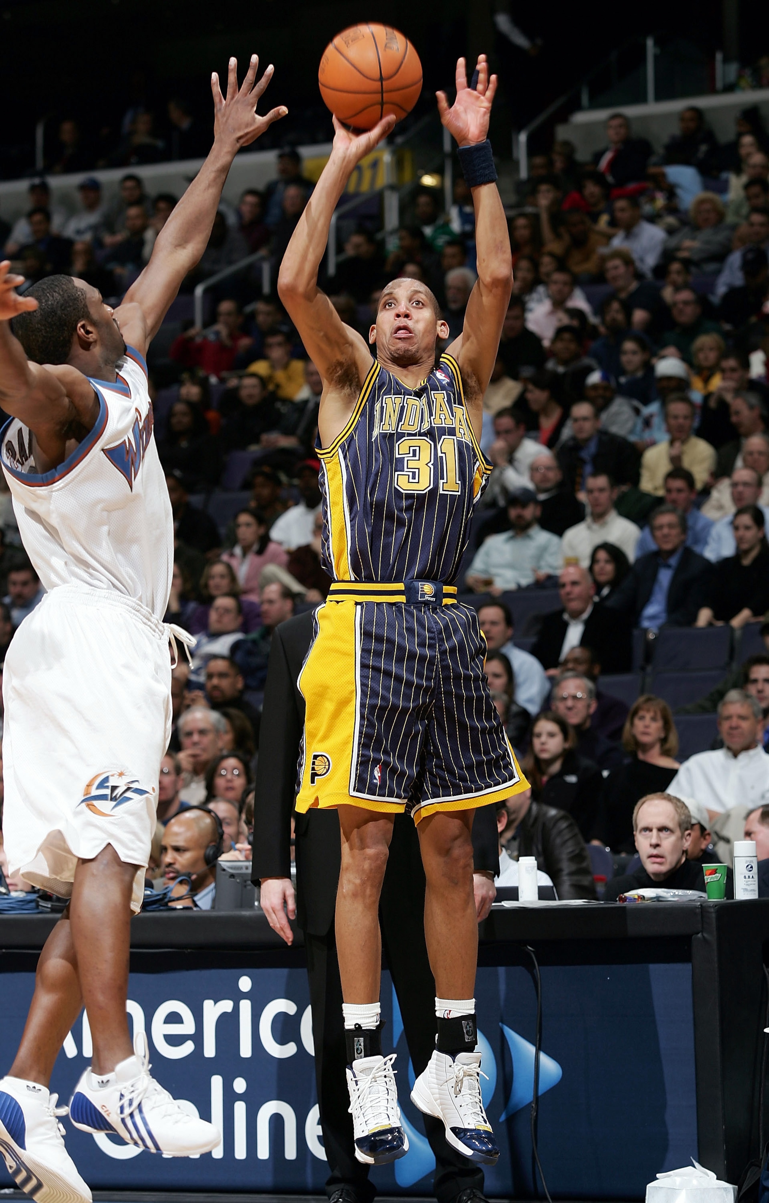WASHINGTON - FEBRUARY 7:  Reggie Miller #31 of the Indiana Pacers takes a shot over Gilbert Arenas #0 of the Washington Wizards during NBA action on February 7, 2005 at the MCI Center in Washington D.C.  NOTE TO USER:  User expressly acknowledges and agre