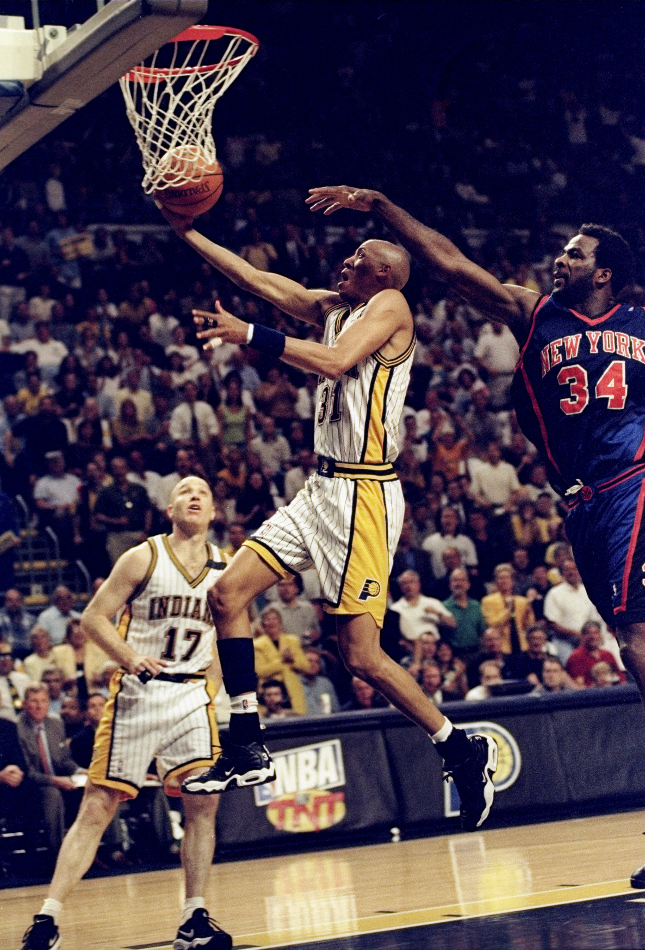 13 May 1998: Reggie Miller #31 of the Indianapolis Pacers jumps to make a lay-up as Charles Oakley #34 of the New York Knicks reaches to block at Market Square Arena in Indianapolis, Indiana. The Pacers defeated the Knicks 99-88. Mandatory Credit: Vincent