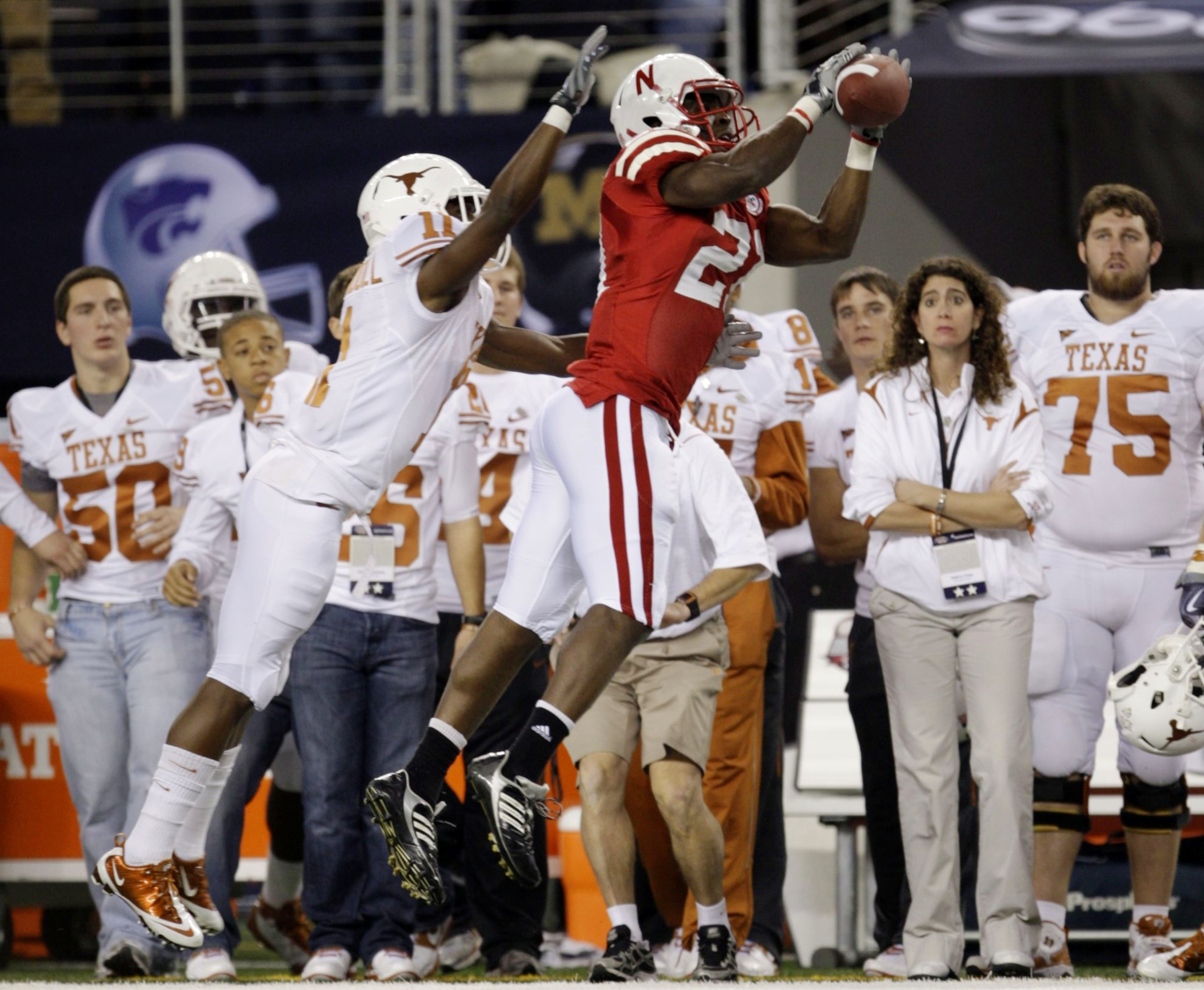 ARLINGTON, TX - DECEMBER 5:  Prince Amukamara #21 of the Nebraska Cornhuskers catches the ball for an interception in the first quarter in front of James Kirkendoll #11 of the Texas Longhorns at Cowboys Stadium on December 5, 2009 in Arlington, Texas. (Ph