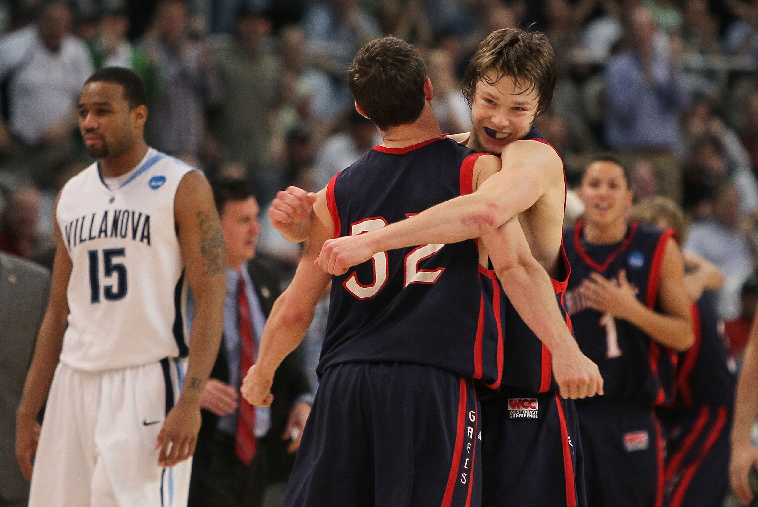 PROVIDENCE, RI - MARCH 20:  Mickey McConnell #32 is hugged by Matthew Dellavedova #4 of the Saint Mary's Gaels after a win as Reggie Redding #15 of the Villanova Wildcats leaves the court during the second round of the 2010 NCAA men's tournament at Dunkin