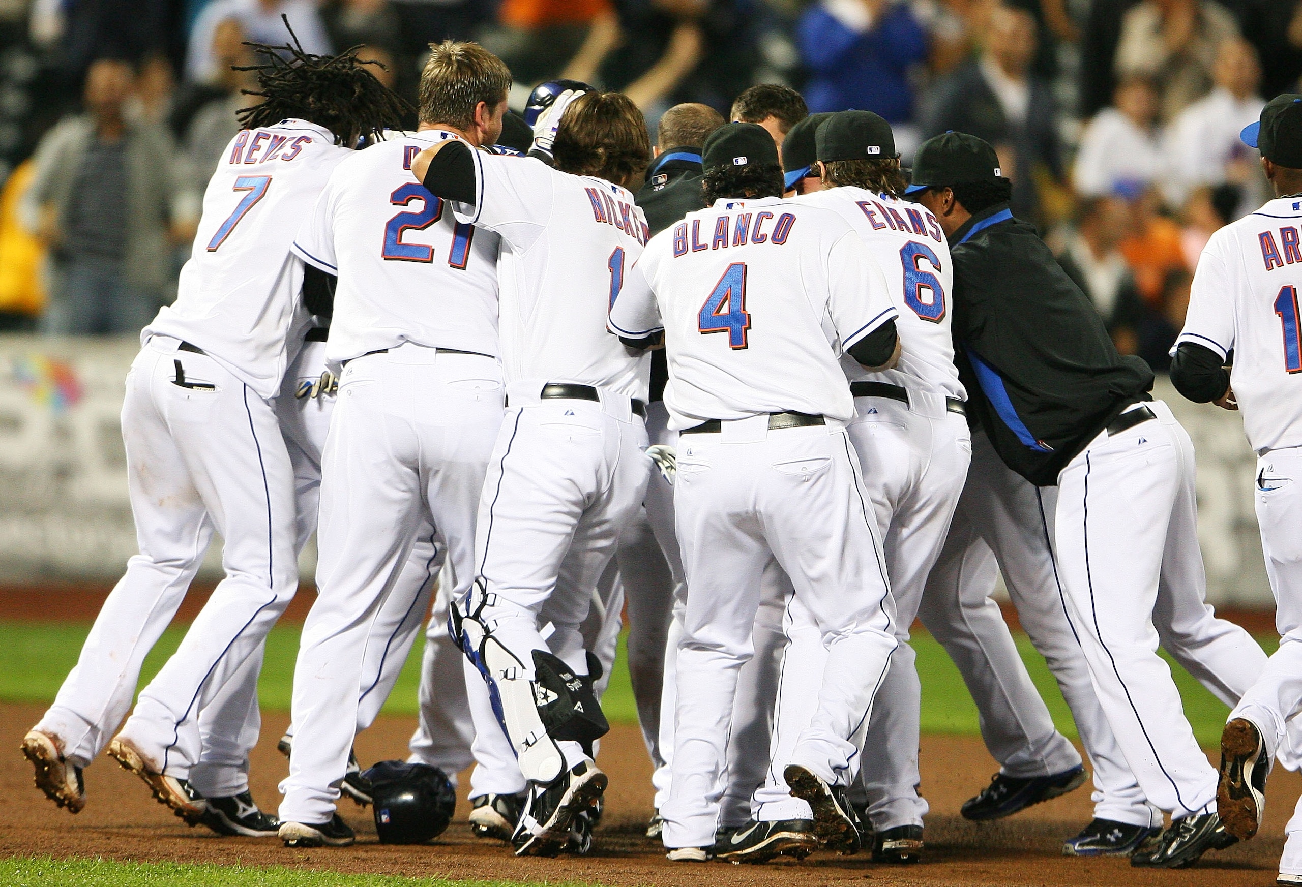 NEW YORK - SEPTEMBER 28: Members of the New York Mets surround Ruben Tejada #11 after he hit a walk off two run double in the ninth inning to defeat the Milwaukee Brewers 4 - 3 on September 28, 2010 at Citi Field in the Flushing neighborhood of the Queen NEW YORK - SEPTEMBER 28: Members of the New York Mets surround Ruben Tejada #11 after he hit a walk off two run double in the ninth inning to defeat the Milwaukee Brewers 4 - 3 on September 28, 2010 at Citi Field in the Flushing neighborhood of the Queen