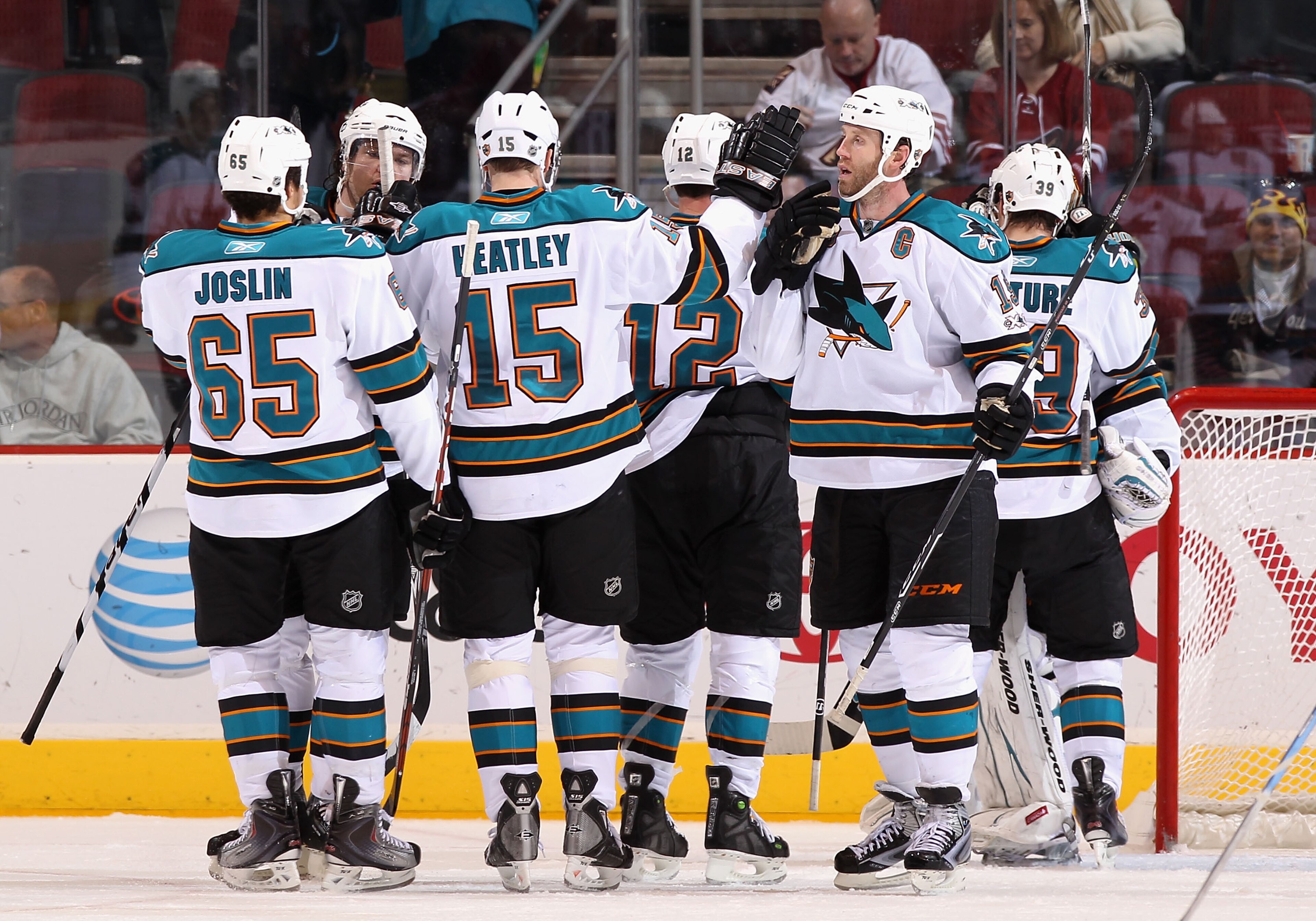 GLENDALE, AZ - JANUARY 17:  Joe Thornton #19 of the San Jose Sharks celebrates with teammates after the NHL game against the Phoenix Coyotes at Jobing.com Arena on January 17, 2011 in Glendale, Arizona.  The Sharks defeated the Coyotes 4-2.  (Photo by Chr