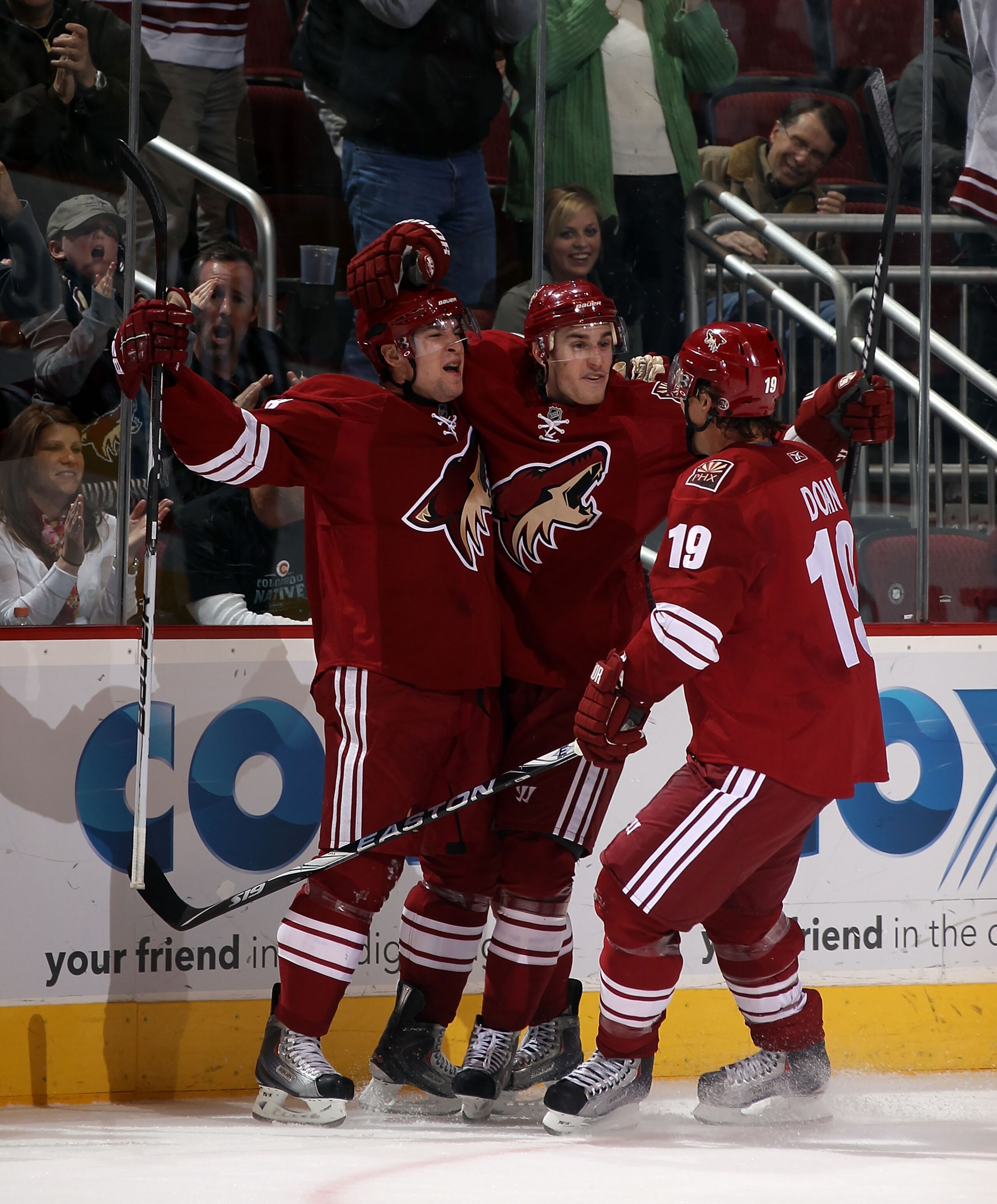 GLENDALE, AZ - FEBRUARY 07:  Scottie Upshall #8 (L) of the Phoenix Coyotes scores a second period goal against the Colorado Avalanche and is joined by Kyle Turris #91 (C) and Shane Doan #19 (R) at the Jobing.com Arena on February 7, 2011 in Glendale, Ariz