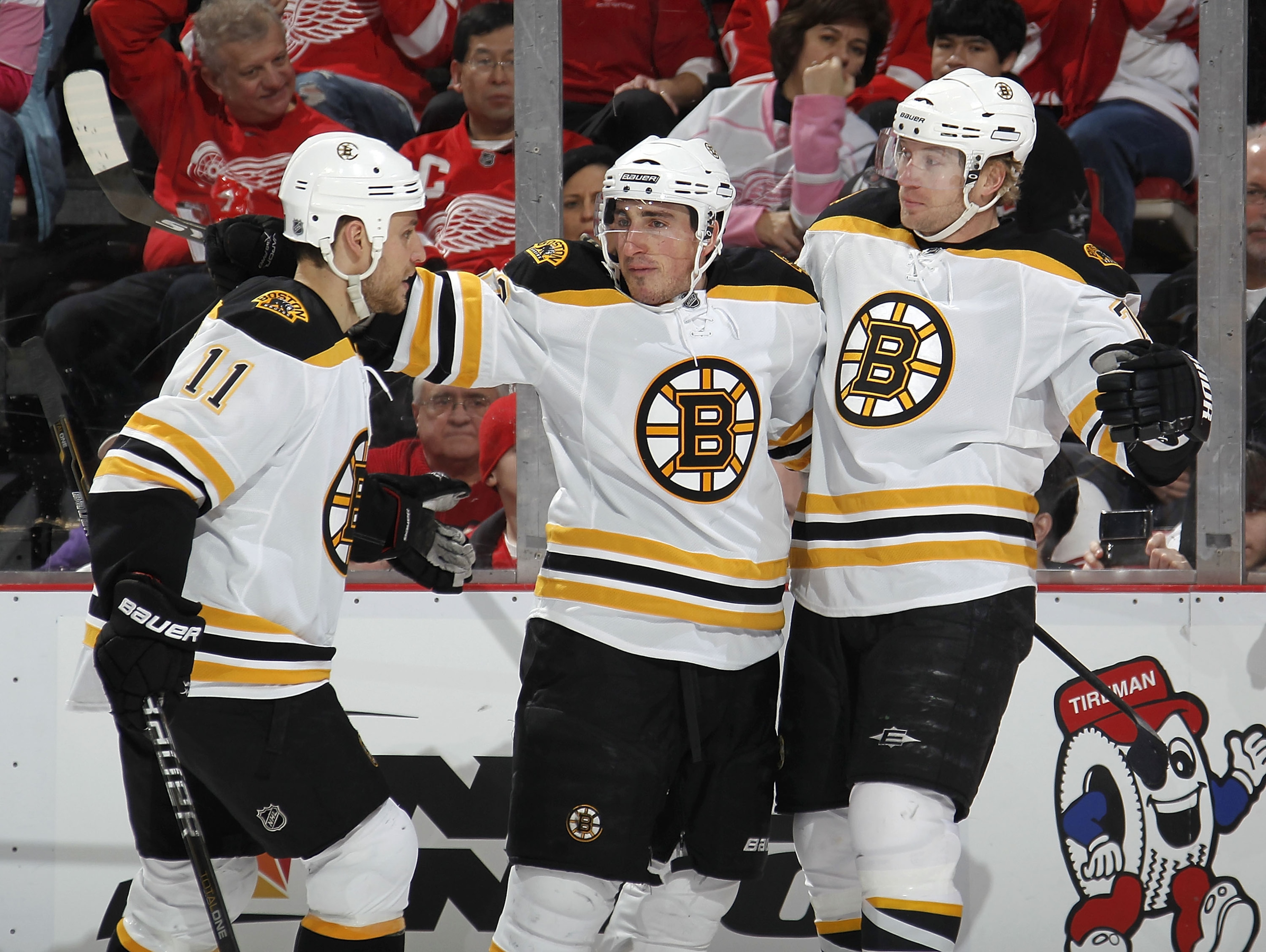 DETROIT, MI - FEBRUARY 13:  Brad Marchand #63 of the Boston Bruins celebrates a first period goal with Michael Ryder #73 and Gregory Campbell #11 while playing the Detroit Red Wings on February 13, 2011 at Joe Lewis Arena in Detroit, Michigan.  (Photo by